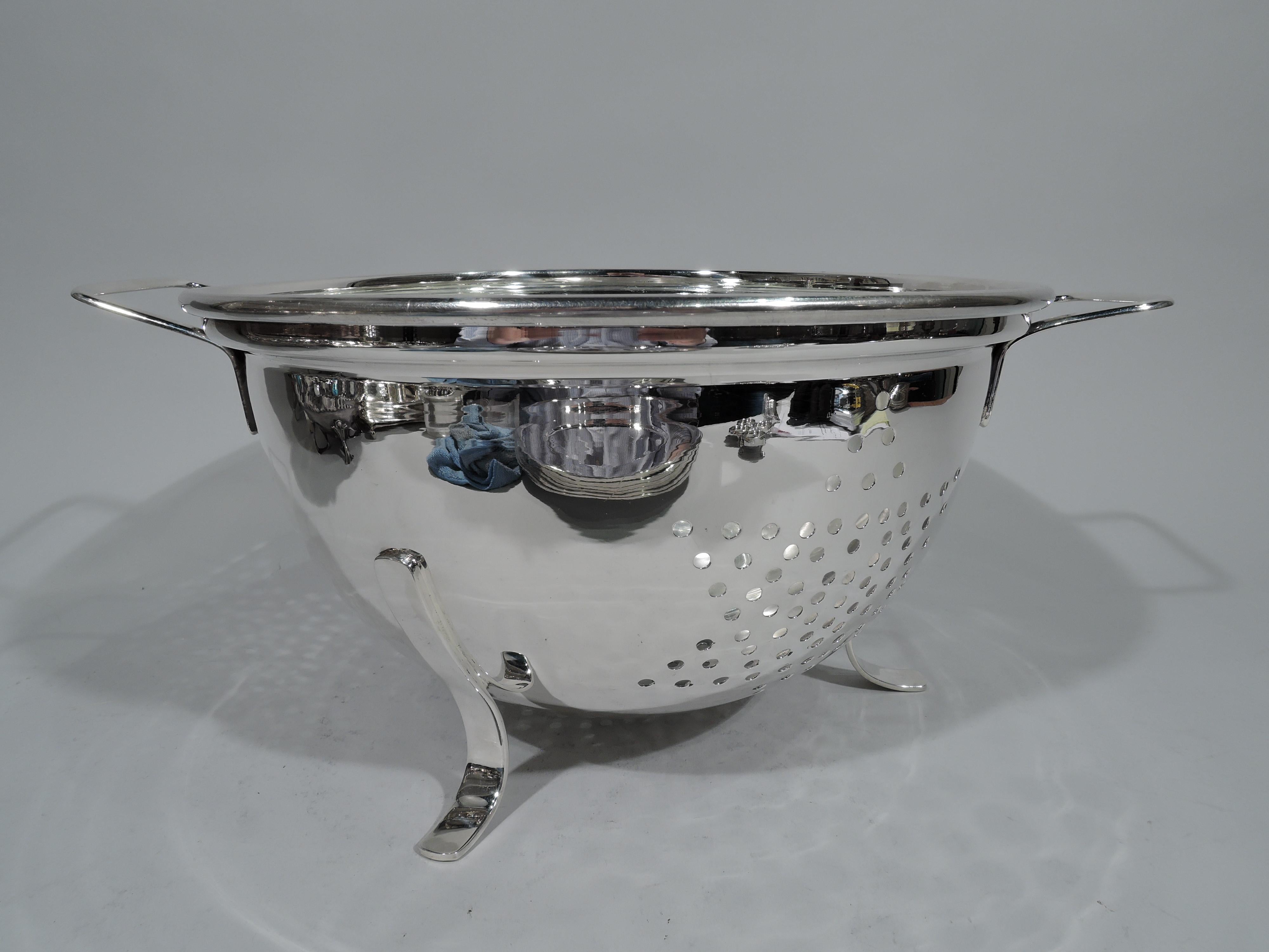 Super luxurious sterling silver colander. Retailed by Cartier in New York. Round bowl with two bracket side handles and 3 scrolled supports. Four pierced stars. A practical kitchen accessory wrought in precious metal. Fully marked including