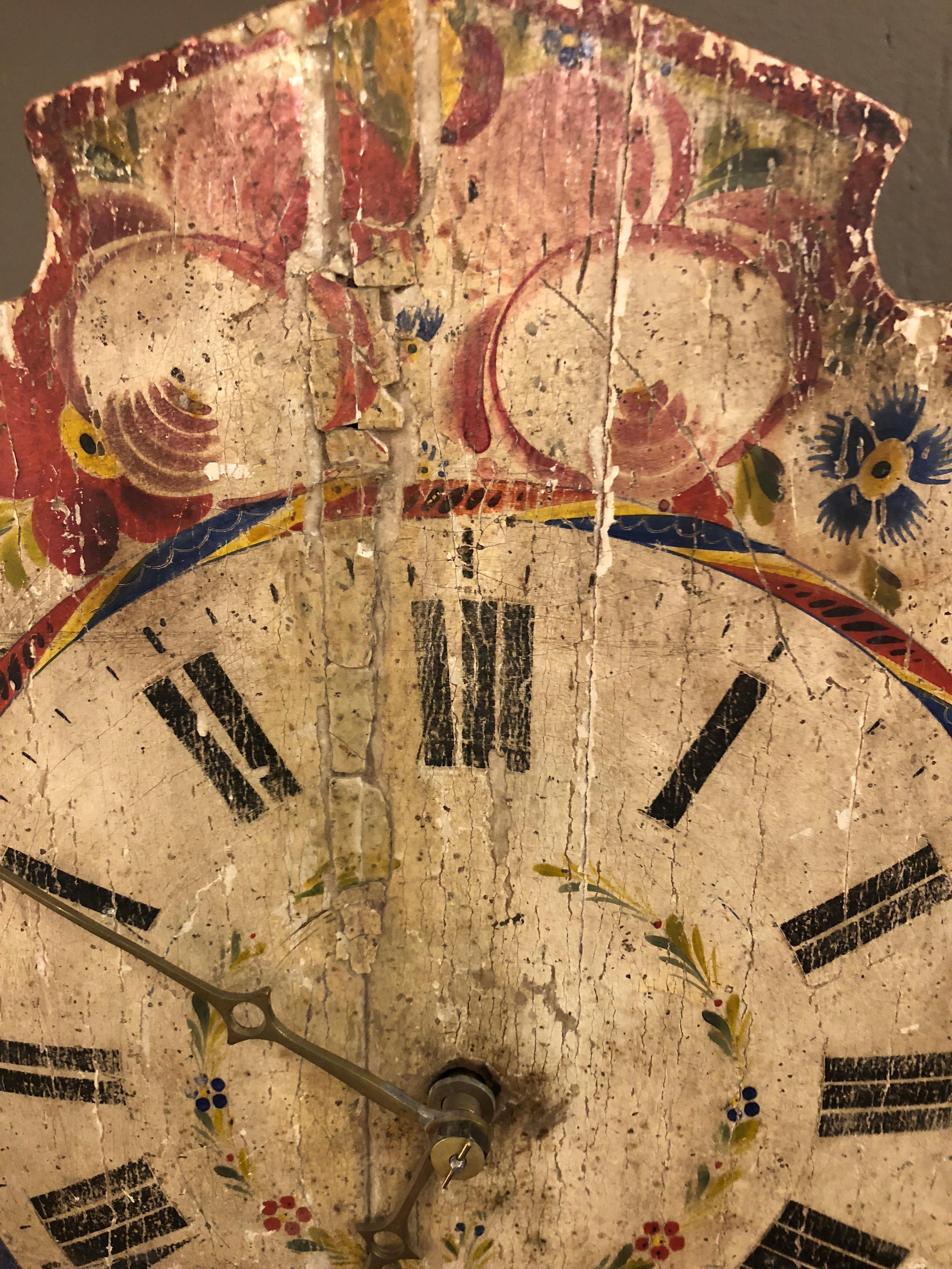 Charming antique painted clock with chippy faded patina. Includes two weights and a pendulum. No idea if this can be made to work, but looks like the mechanism is there.