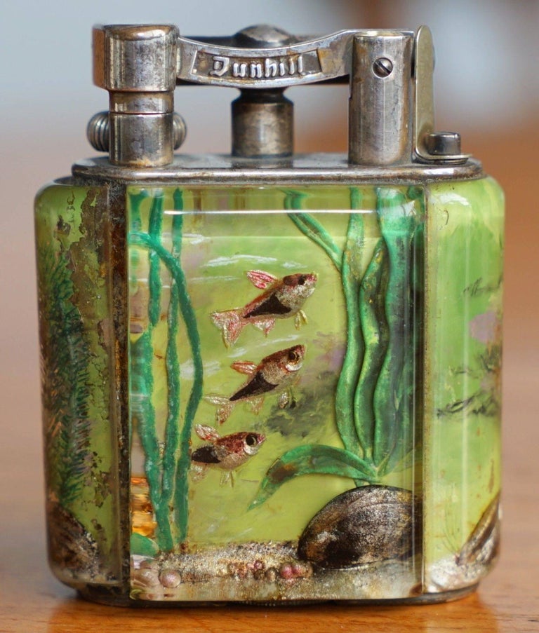 We are delighted to offer for sale is this very rare original 1950s handmade in England Dunhill Aquarium table lighter

I have another of these listed on my other items, its classed as the giant and is in museum condition

This piece is