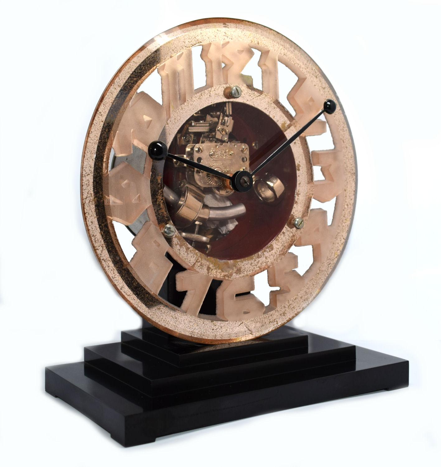 One of the more rare Art Deco clocks is this wonderfully stylish and totally authentic 1930s Art Deco clock by ATO the French clock makers. This clock has a mixtures of materials, mainly Bakelite and pink mirror glass. Very iconic looking clock that