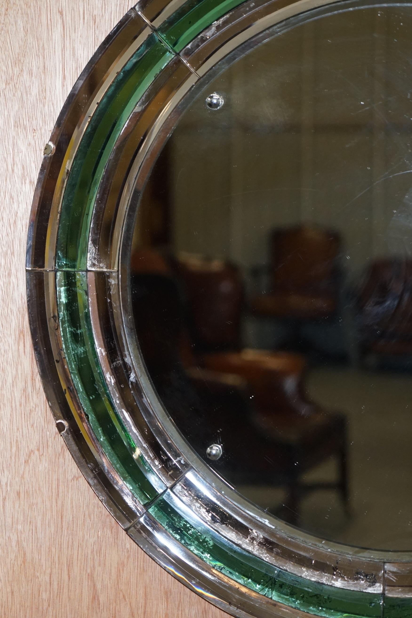 We are delighted to this exceptionally rare and important Art Deco circa 1930s Peach and Murano Emerald glass round wall mirror

What a find, I have never seen a Murano emerald glass mirror before with the Art Deco peach glass mixed in as well and