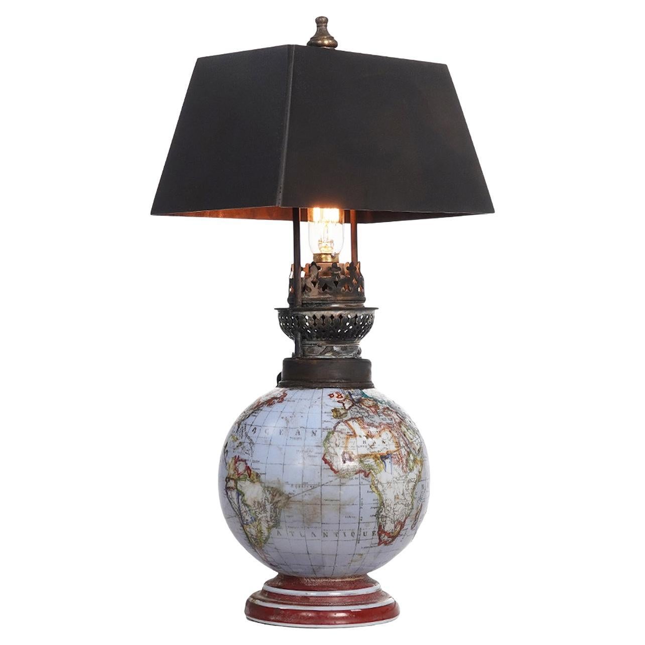 These small glass globe lamps are impossible to find and yet we have a pair. These are highly sought ofter by globe collectors. The globes are different example but they have matching dark brass shades. These could have been early oil lamps that are