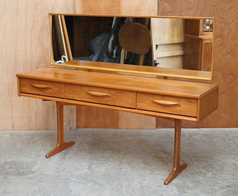 We are delighted to offer this very well made mid century modern Austinsuite teak dressing table with the super rare single row of drawers, original mirror and matching stool

If retro 60’s cool is what you’re in the market for then look no