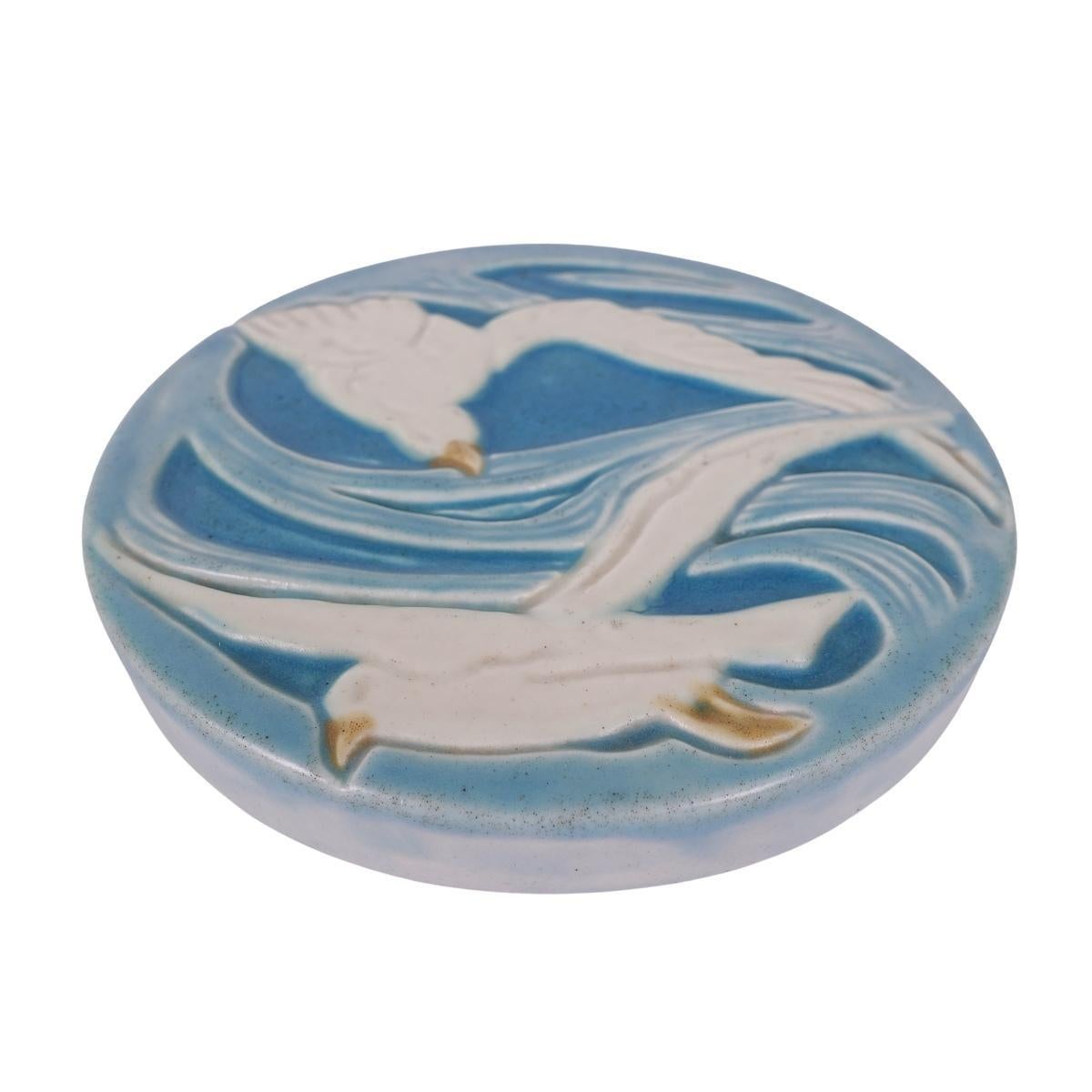 Offering this gorgeous hand-painted vellum Rookwood pottery trivet tile featuring two seagull designs. This tile trivet is hand-painted with beautiful hues of blue and aqua, cream and yellow beak accents. Signed with the impressed 