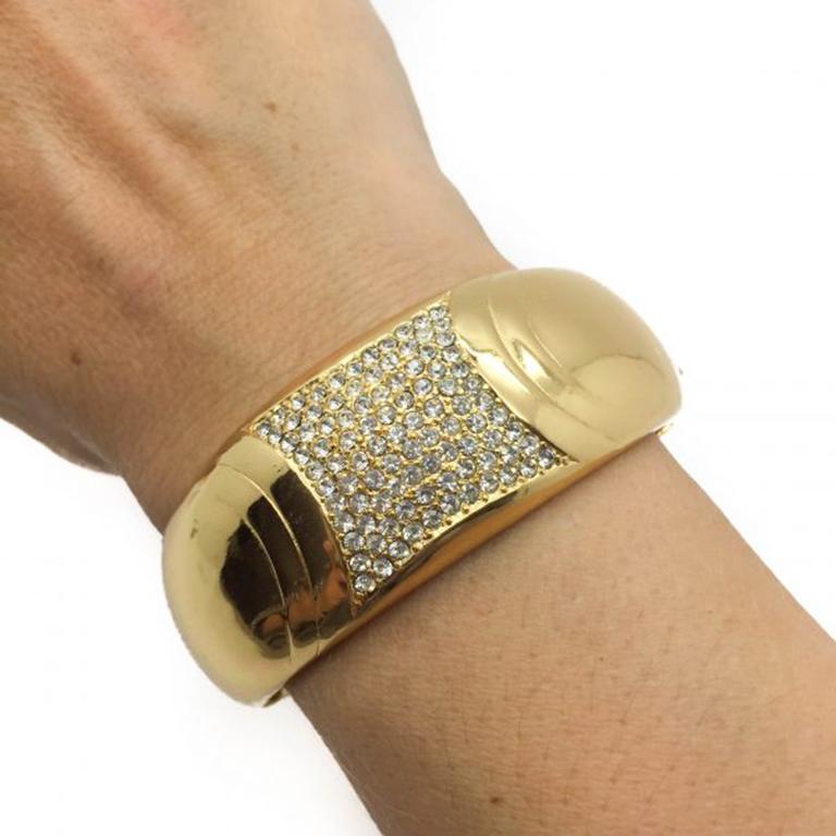 A super stylish and amazing quality Vintage Dior Cuff dating to the 1990s. A very substantial, striking and stylish Vintage Dior Cuff heavily plated in high carat gold that will not wear. The rhinestones in the centre of the Dior cuff sparkle