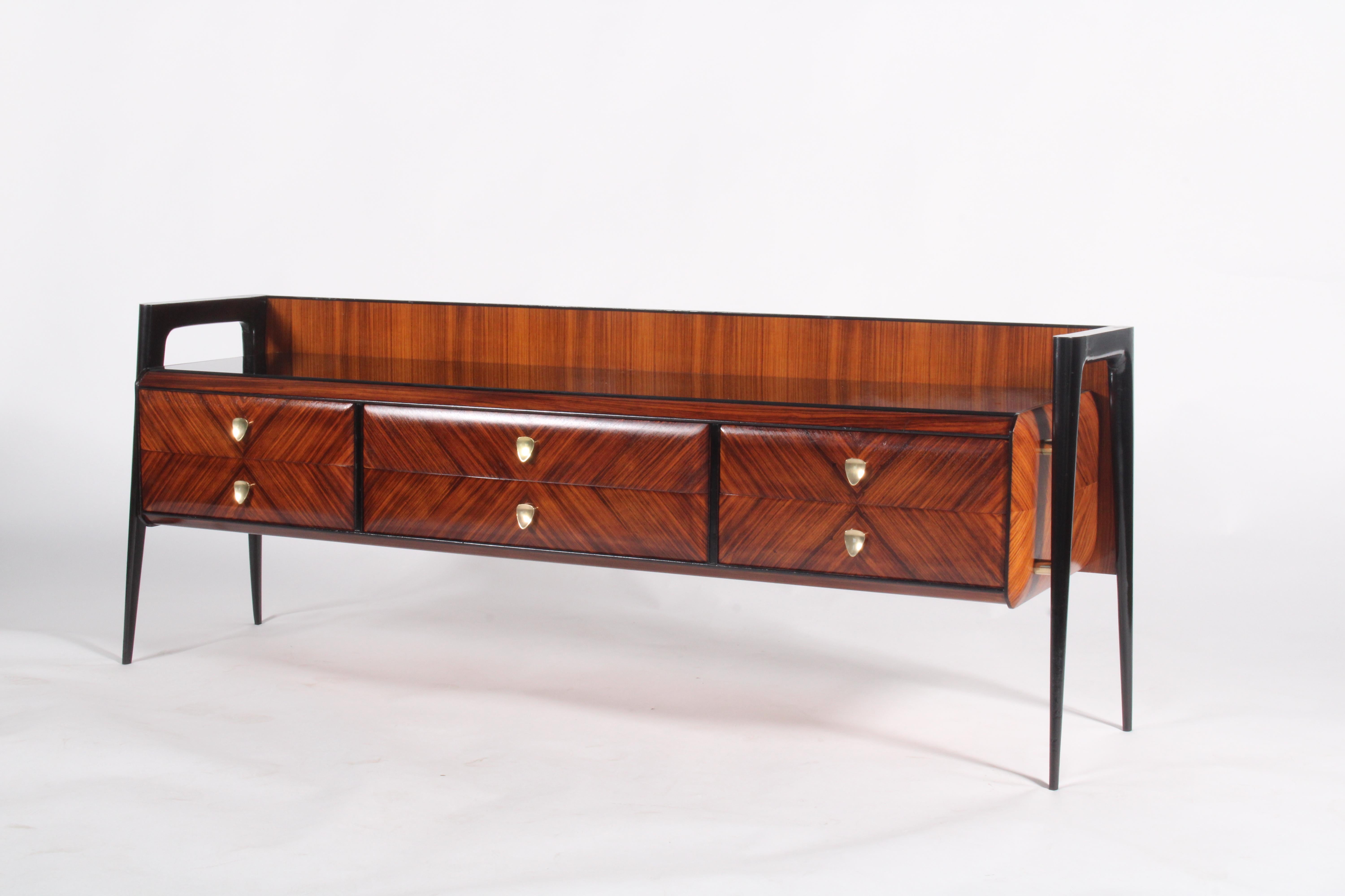 An exceptional example of mid-century Italian design, this original sideboard dates from the 1950s and showcases the elegant craftsmanship and sophisticated materials that define the era. Constructed in richly patterned rosewood, the piece features