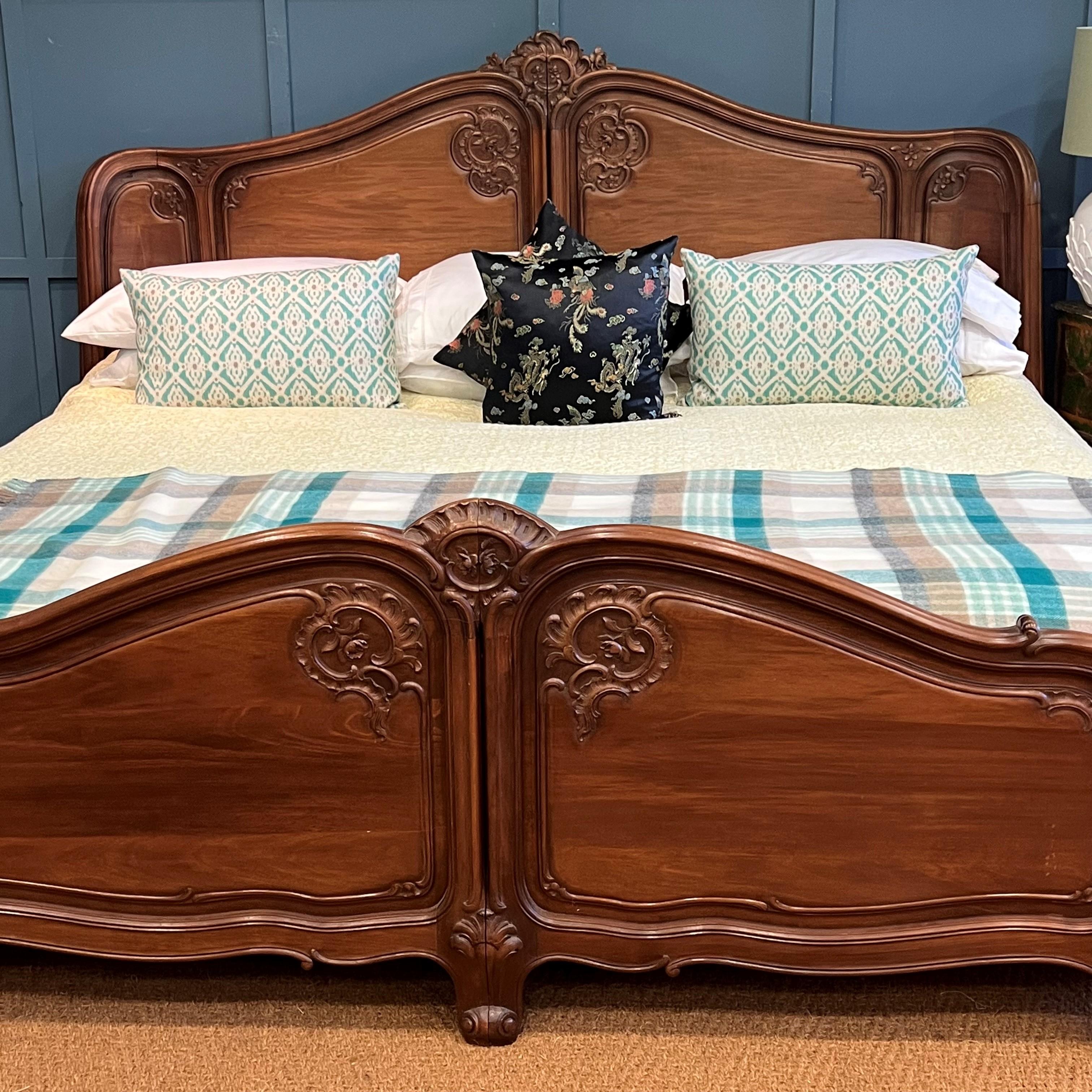 Large, elegant and extremely rare antique French walnut wooden bedstead circa 1900. The frame has a full corbeille, having both a curved head and foot end. The frame is in the Louis XV style. Excellent quality carvings and pretty shaped fielded