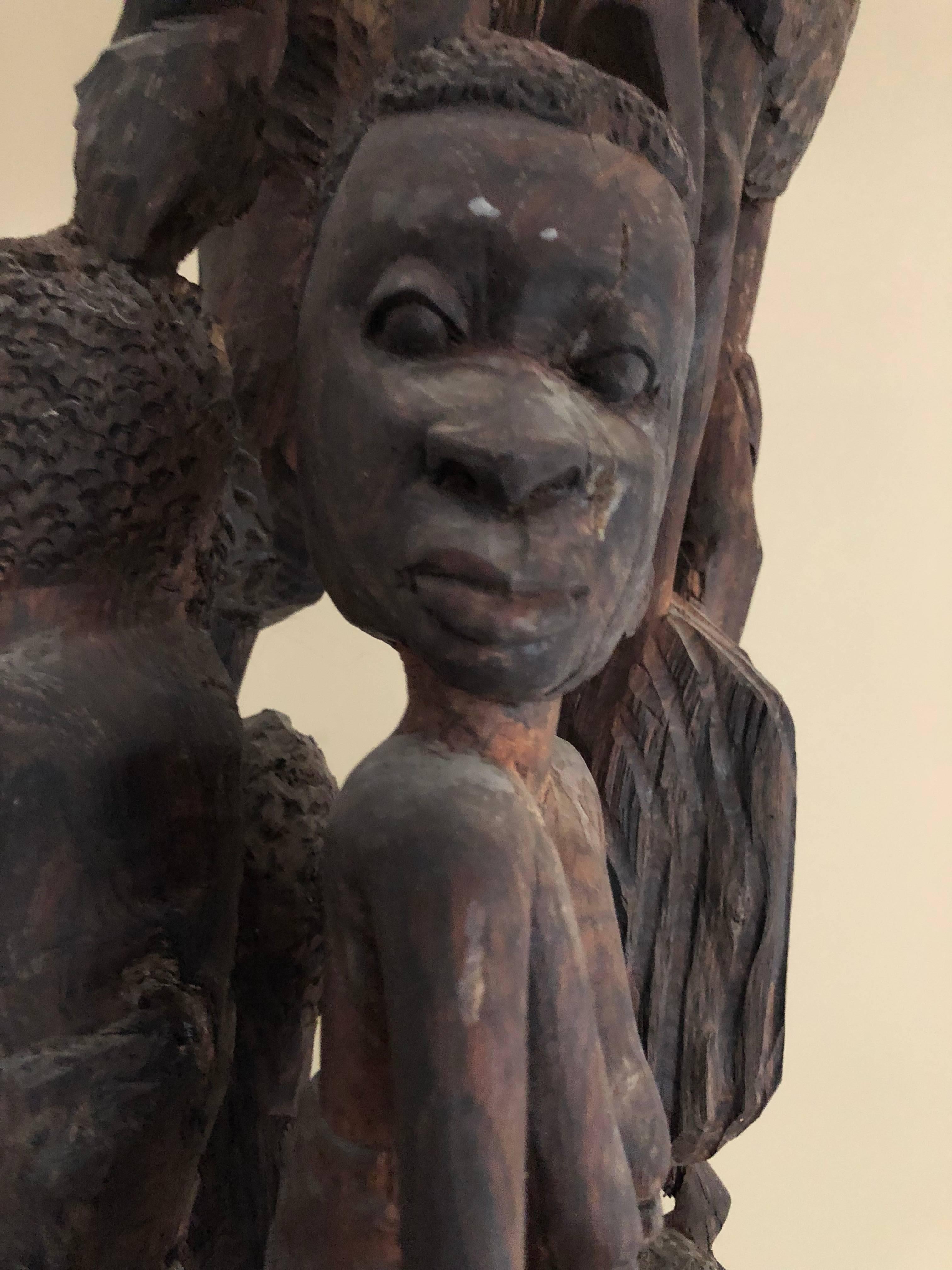 Monumental in size, this hand-carved African sculpture stands 7.5 feet tall and depicts people in various poses. The intricate detail of each person is astounding. The sculpture’s base has been carved from the trunk of a tree. Truly one-of-a-kind.
