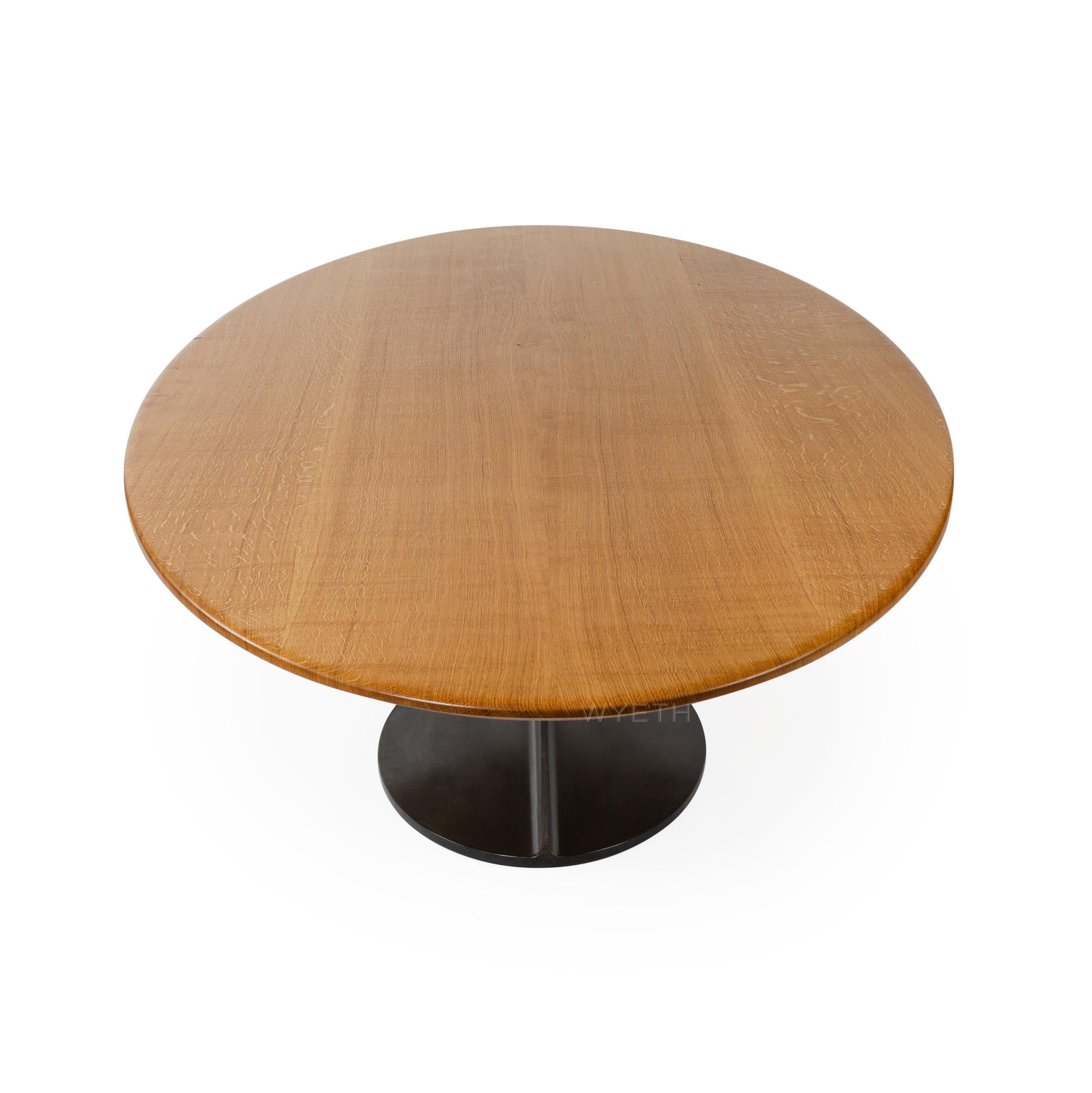 A custom ellipse table with a solid oak top and blackened steel base made by the Wyeth Workshop in NY. Available in custom sizes, woods and finishes.