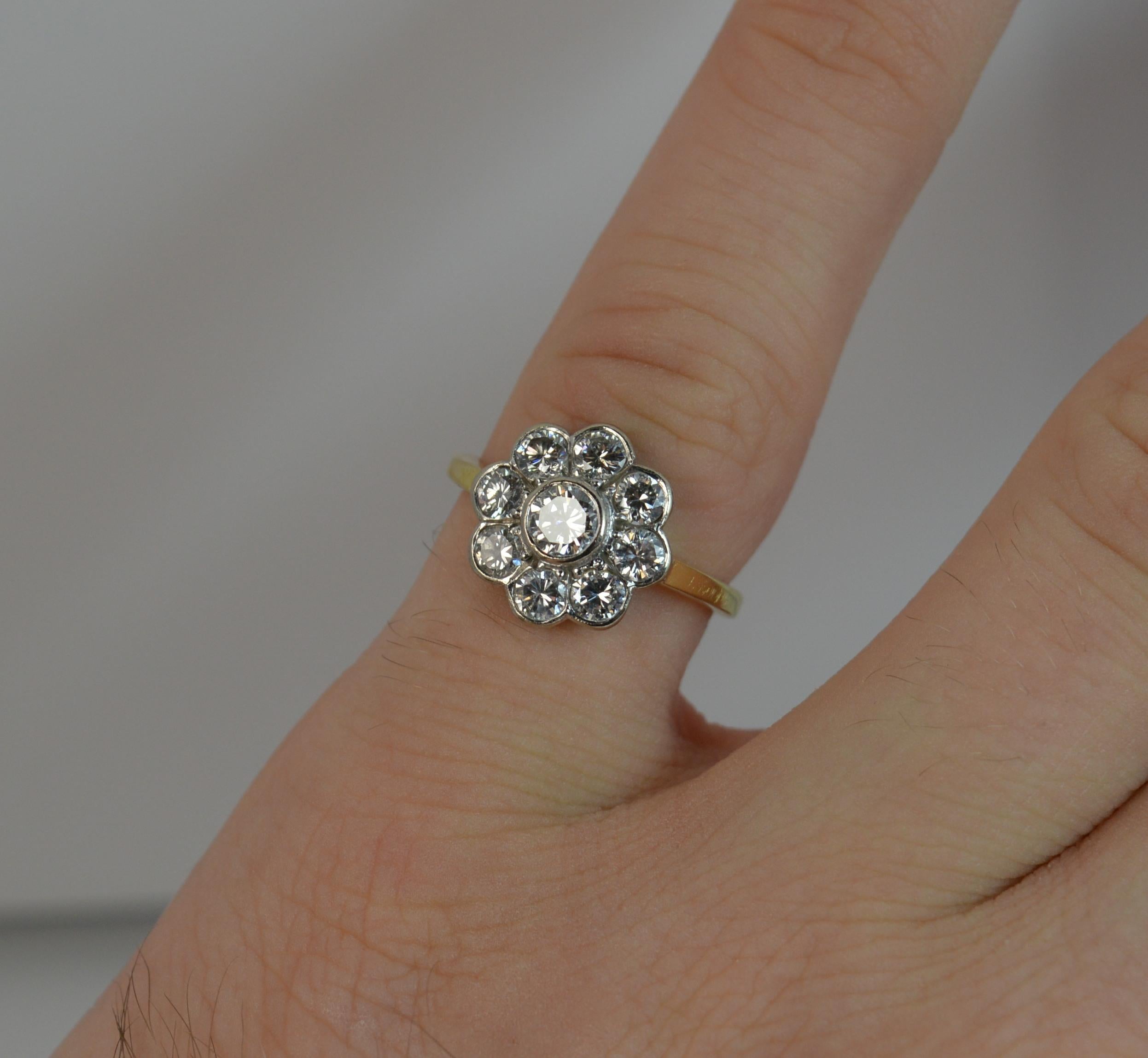 A stunning Diamond and 18ct Gold cluster ring.
SIZE ; J UK, 4 3/4 US, sizeable
Designed as a daisy cluster comprising of eight round brilliant cut diamonds of uniform size with slightly larger diamond to the centre. All in a white gold bezel