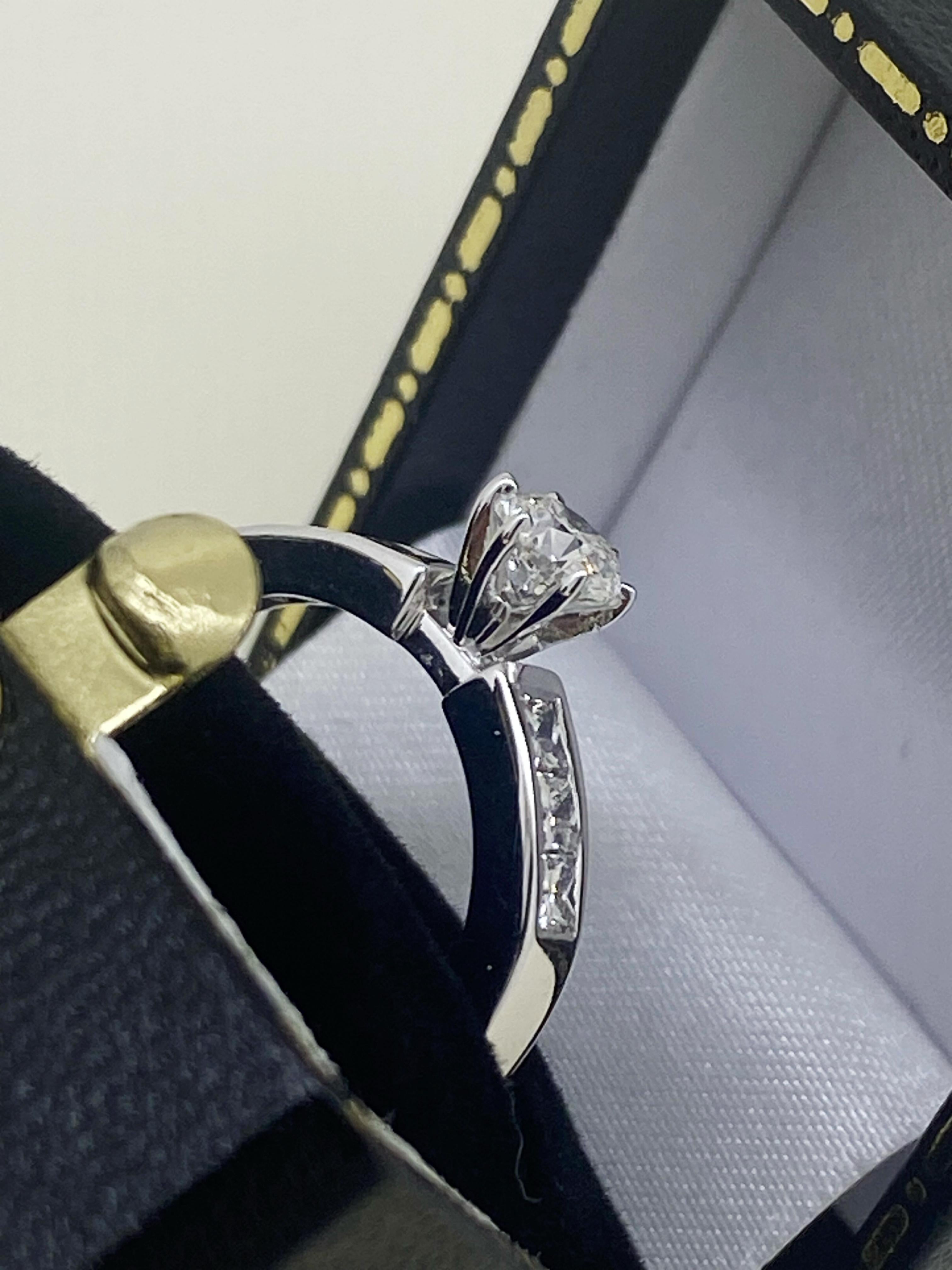 Of timeless & visually striking 
Solitaire with Accents design 
this piece is centrally 6-claw set with 
a sparkling Round Brilliant Cut Diamond – 
of impressive size - 0.45ct 
of G colour, VS clarity & sunlike brilliance, 
securely set in 18K White