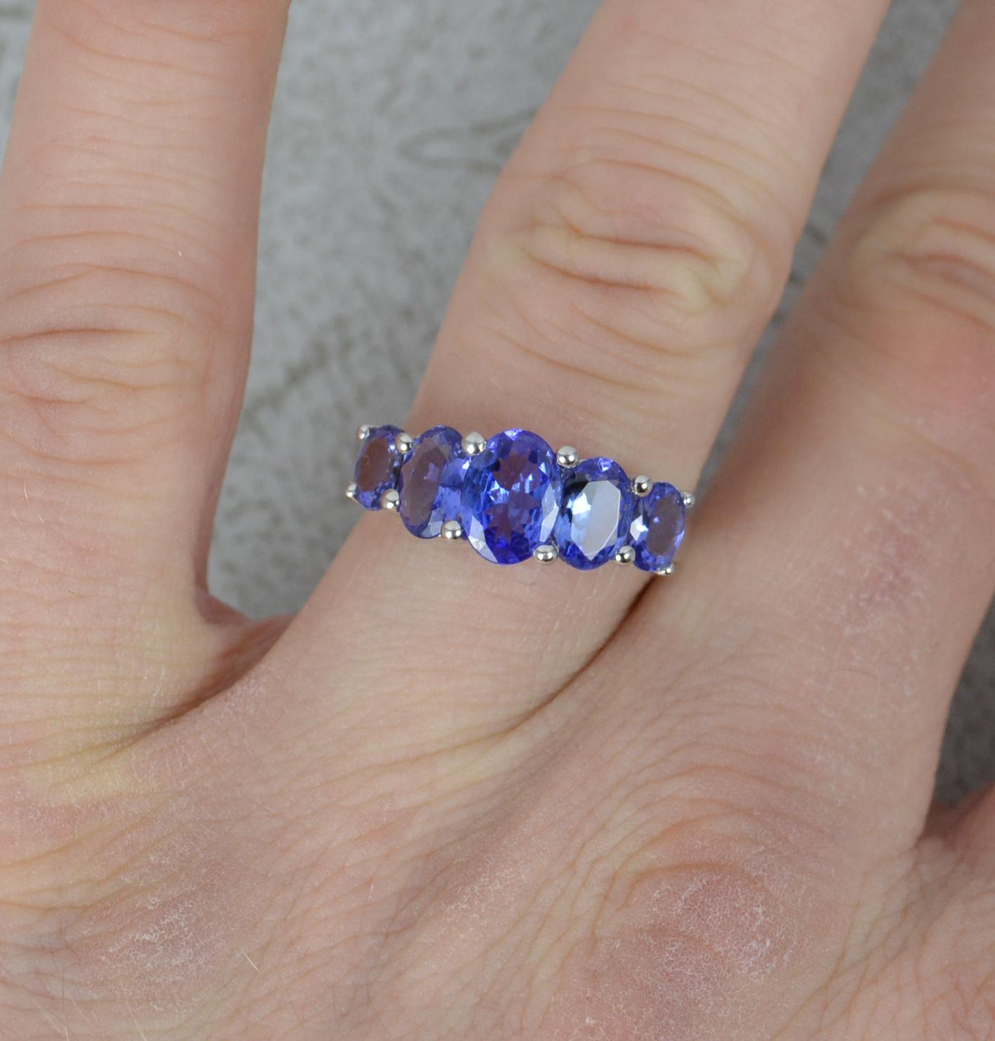 A superb ladies tanzanite ring.
Solid 14 carat white gold example.
Set with five oval cut, graduated size, blue coloured tanzanite stones.
20mm spread of stones. Protruding 5.5mm off the finger.
CONDITION ; Excellent. Well set stones. Strong, solid