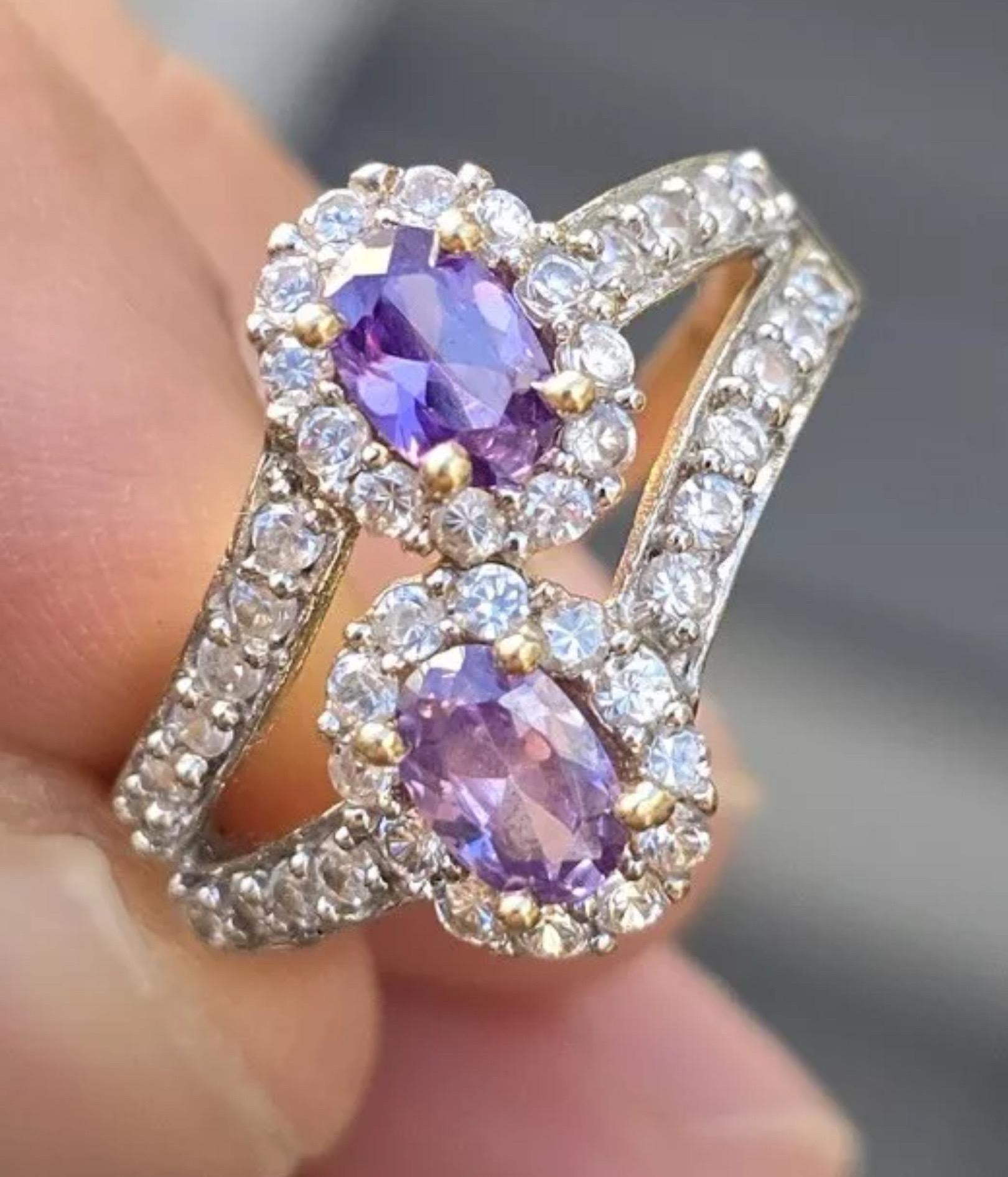 This is a gorgeous, 14 karat yellow gold ring with vivid amethyst stones. The smaller stones are not diamond but just some kind of white stones. We are not sure exactly sure but probably CZ, etc. The weight of the ring is 4.52 grams. The ring size