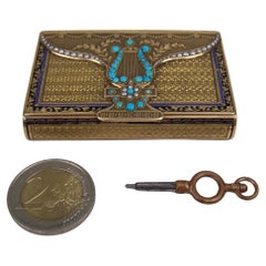 Superb 18K gold "Sur plateau" musical snuff  box purse form
