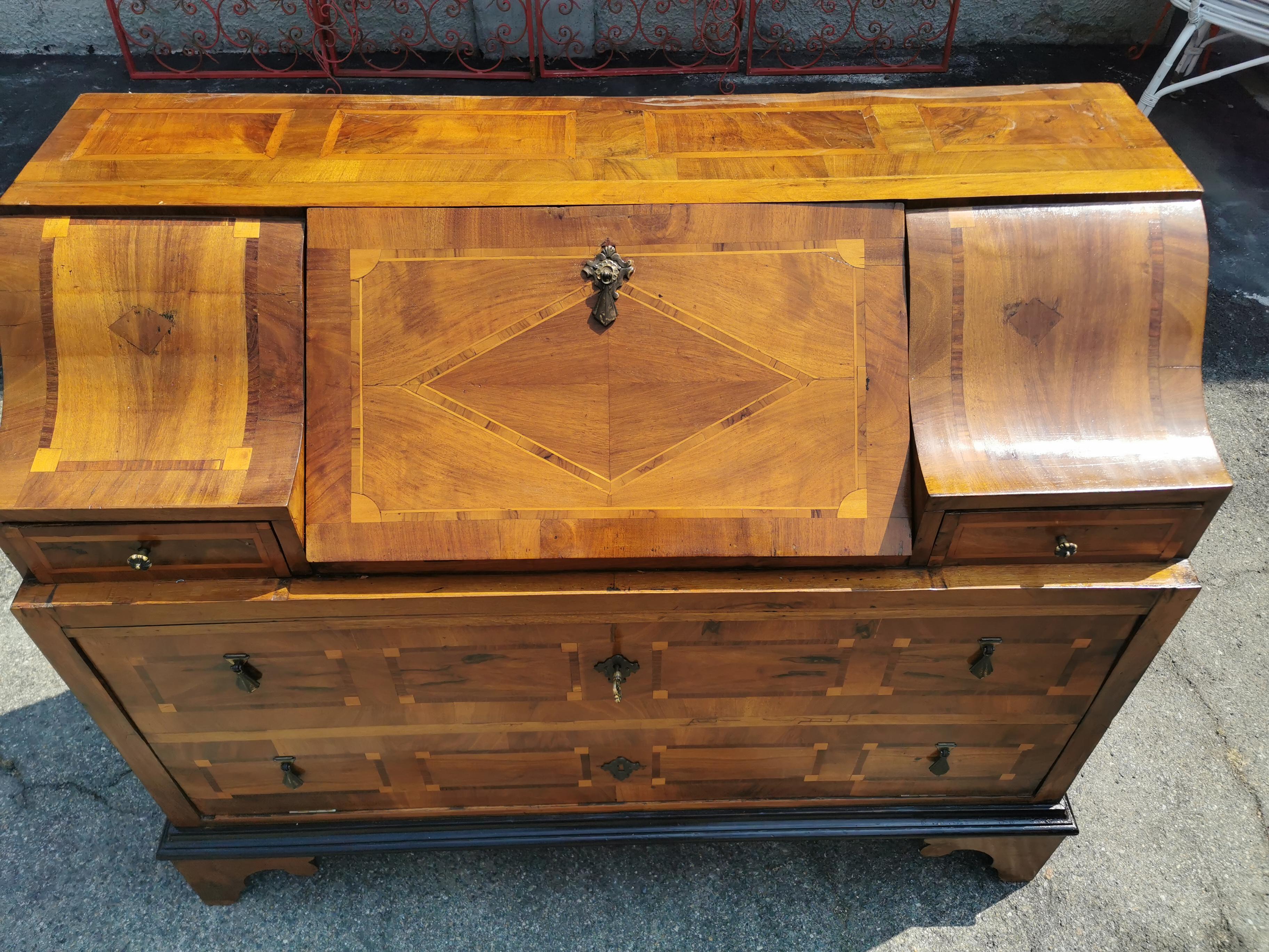 Very rare Italian Trumeau, coming from the city of Roma, Louis XVI era. The workmanship of the feet is also delightful. Rich marquetry work all around the item, quality solid walnut. it is a superb fine antique will definetly change the atmosphere
