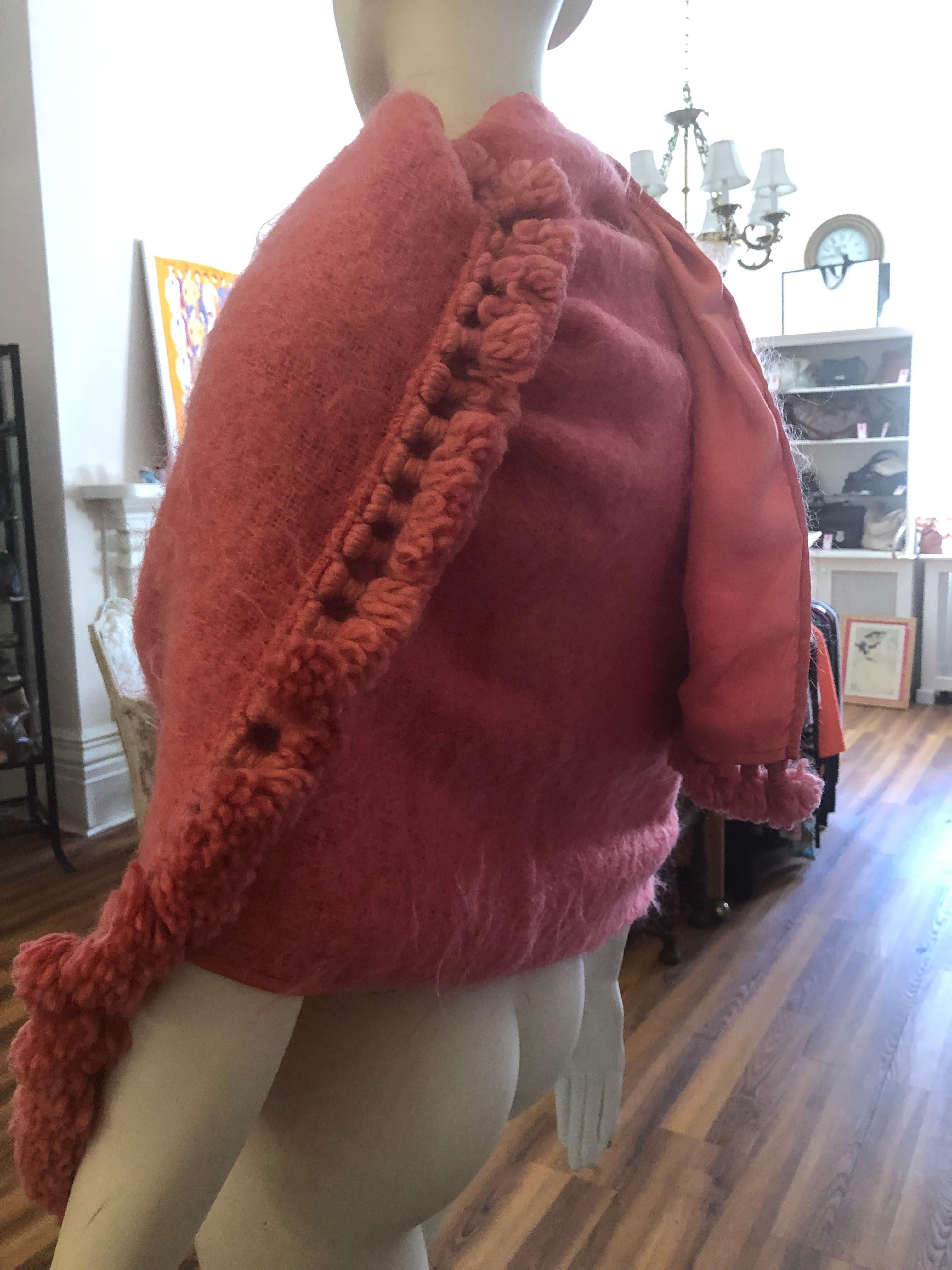 This 1980s Christian Dior Mohair wrap was designed by Marc Bohan and has the serial# 41270.

It is a lovely shade of pink; has tassles/pompom on each end, and silk lining and edging.

Truly a magnificent piece which I marked as good because of the