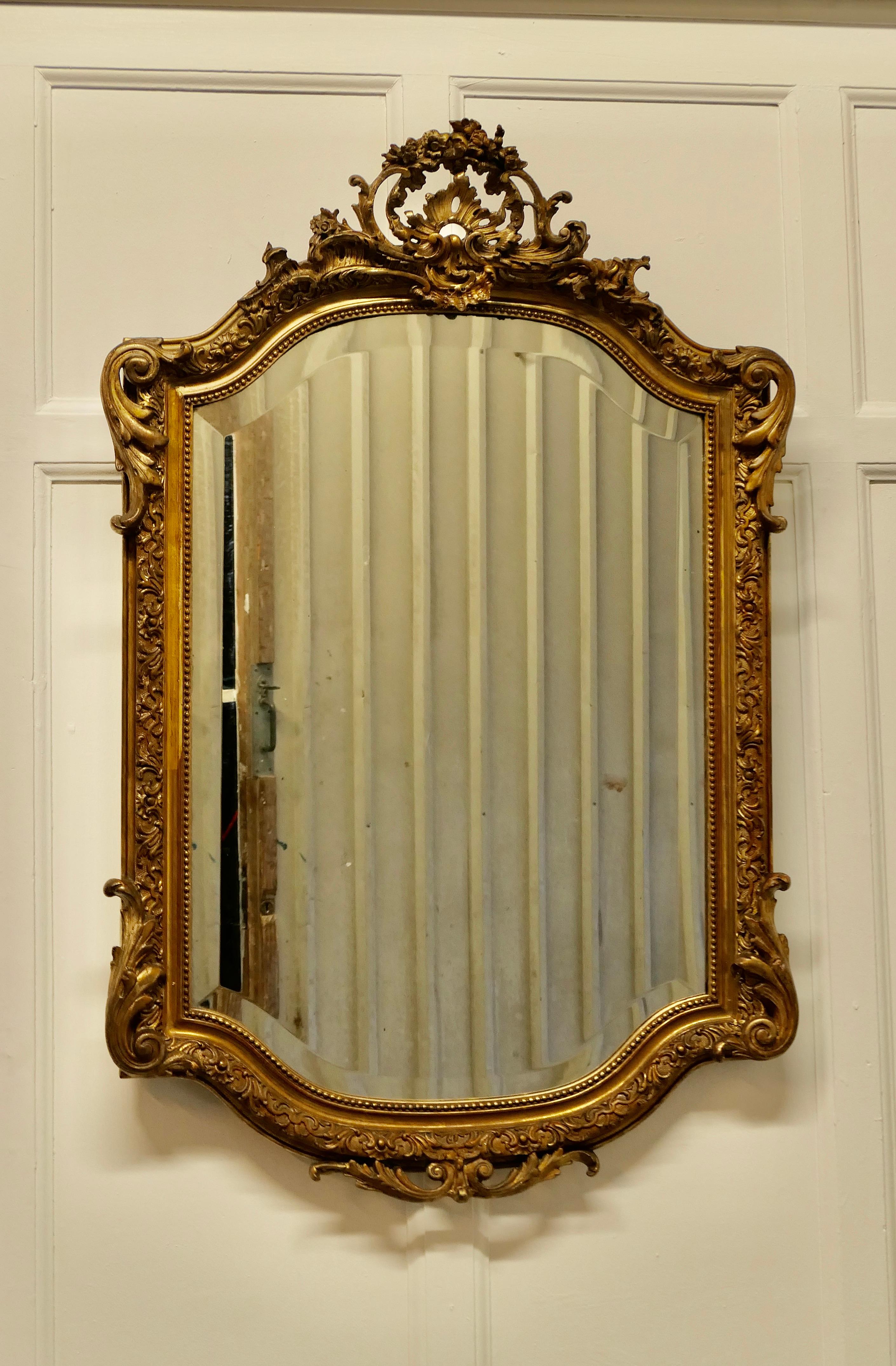 Superb 19th century French gilt pier mirror 

This is a beautifully decorative gold frame mirror it is an unusual shape with gilded carving, a large and intricate piece with a pierced shell and floral decoration at the top and a very attractive