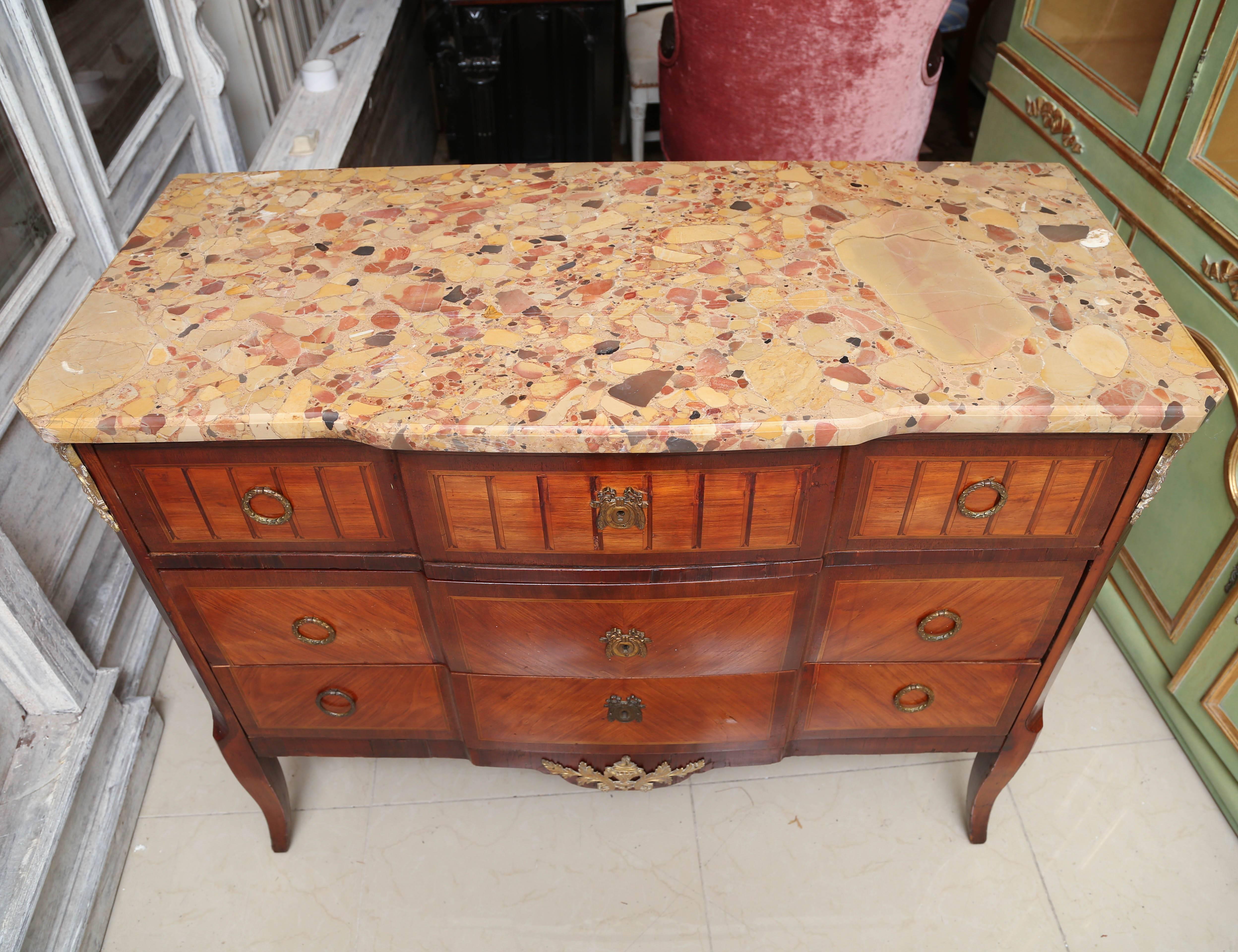 This is a very nice antique marble-top French commode with ormolu mounts to the side and bottom.
It also has inlay to the sides and front.
The drawer linings are sold wood with dovetail joints
Made in France, circa 1890.
The top has a