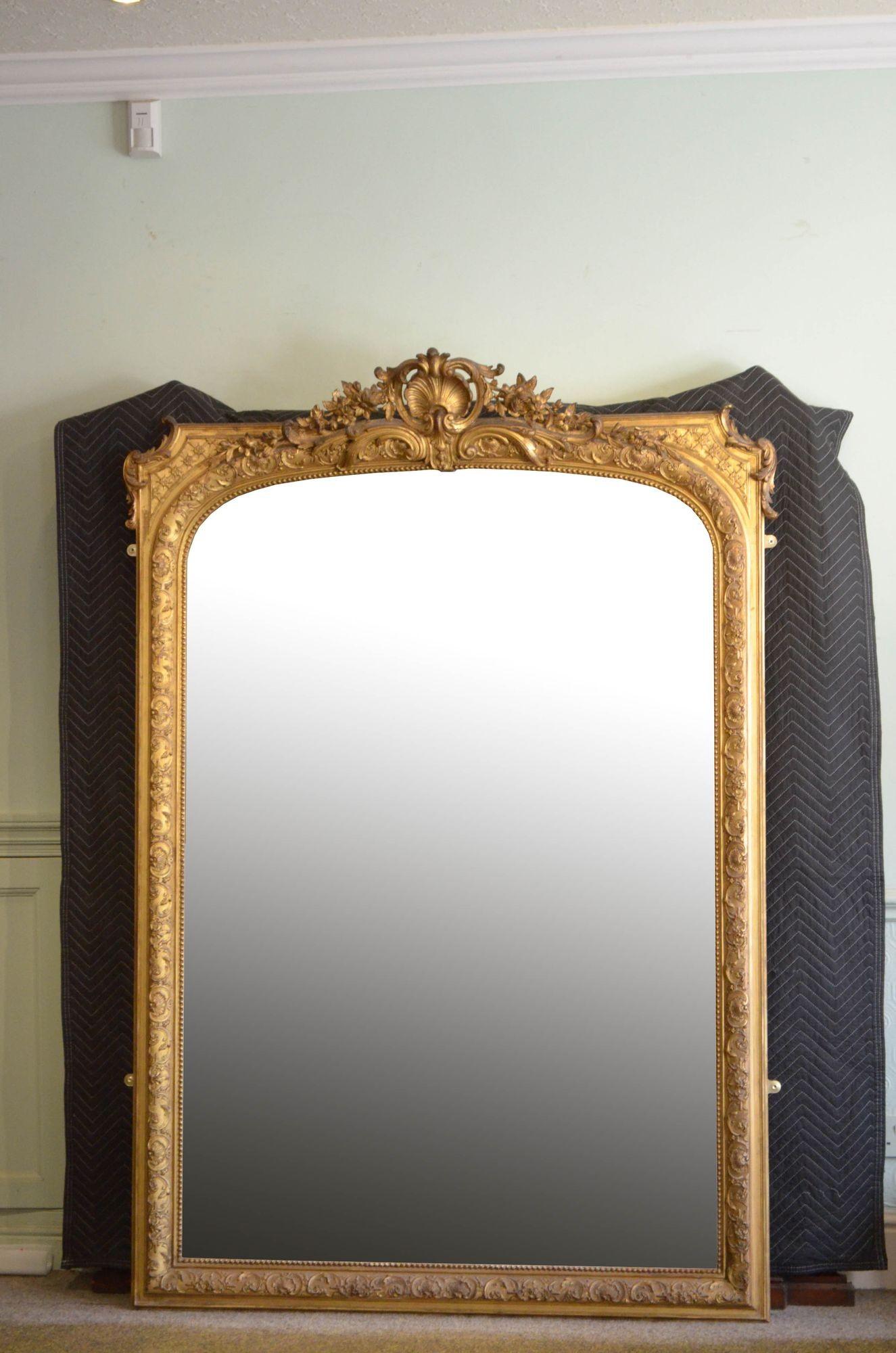 Sn5475 Exceptional 19th century mirror of versatile form (can be hung on the wall or stood on the floor), having original glass with some foxing in beaded flower and shell carved gilded frame with elaborate foliage crest to the centre. This antique