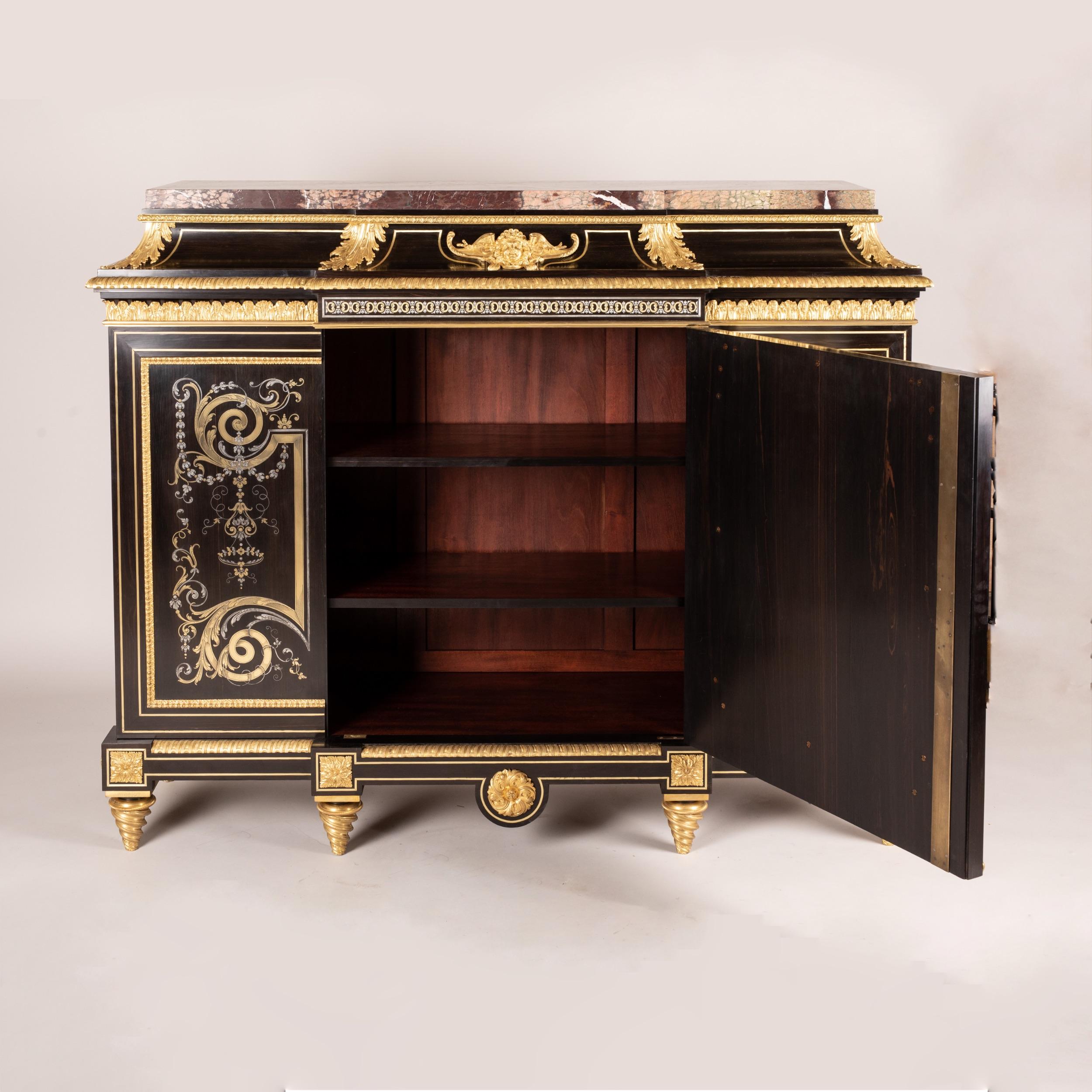 An impressive Marquetry Inlaid cabinet
In the Louis XIV Manner of André-Charles Boulle

Constructed in ebony and ormolu, adorned in première-partie inlay work of engraved brass and pewter; rising from tapering toursade feet; the breakfront façade