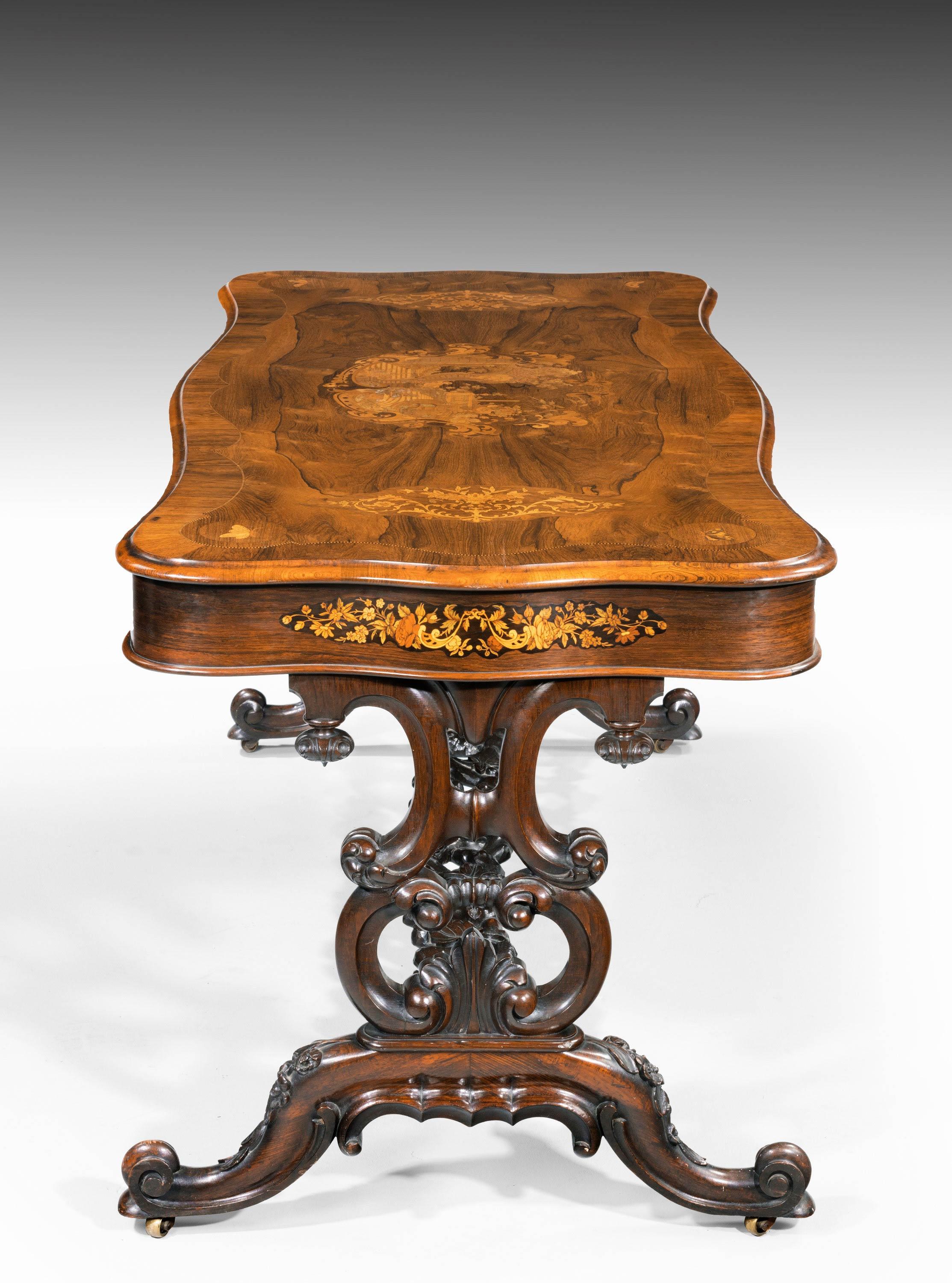 A quite superb 19th century rosewood, kingwood and marquetry center standing table of serpentine outline overall. With a beautifully and elaborately carved stretcher between elegant cabriole supports. The tops and sides of finely executed panels of