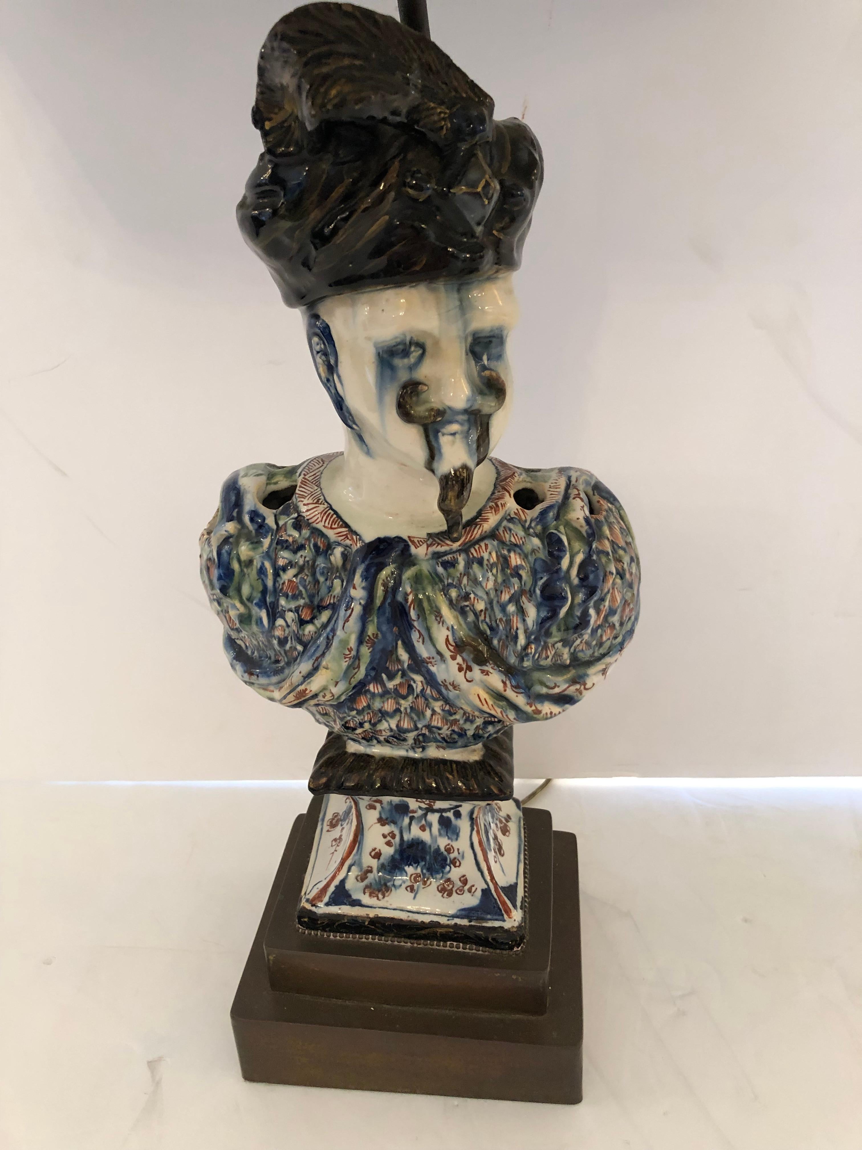 Wonderful and unusual antique French faience table lamp having sculptural blue and white bust of a soldier with jaunty turban on his head. Base is bronzed brass. The custom hand painted shade is absolutely sublime.
Lamp is 7 W x 5 D.