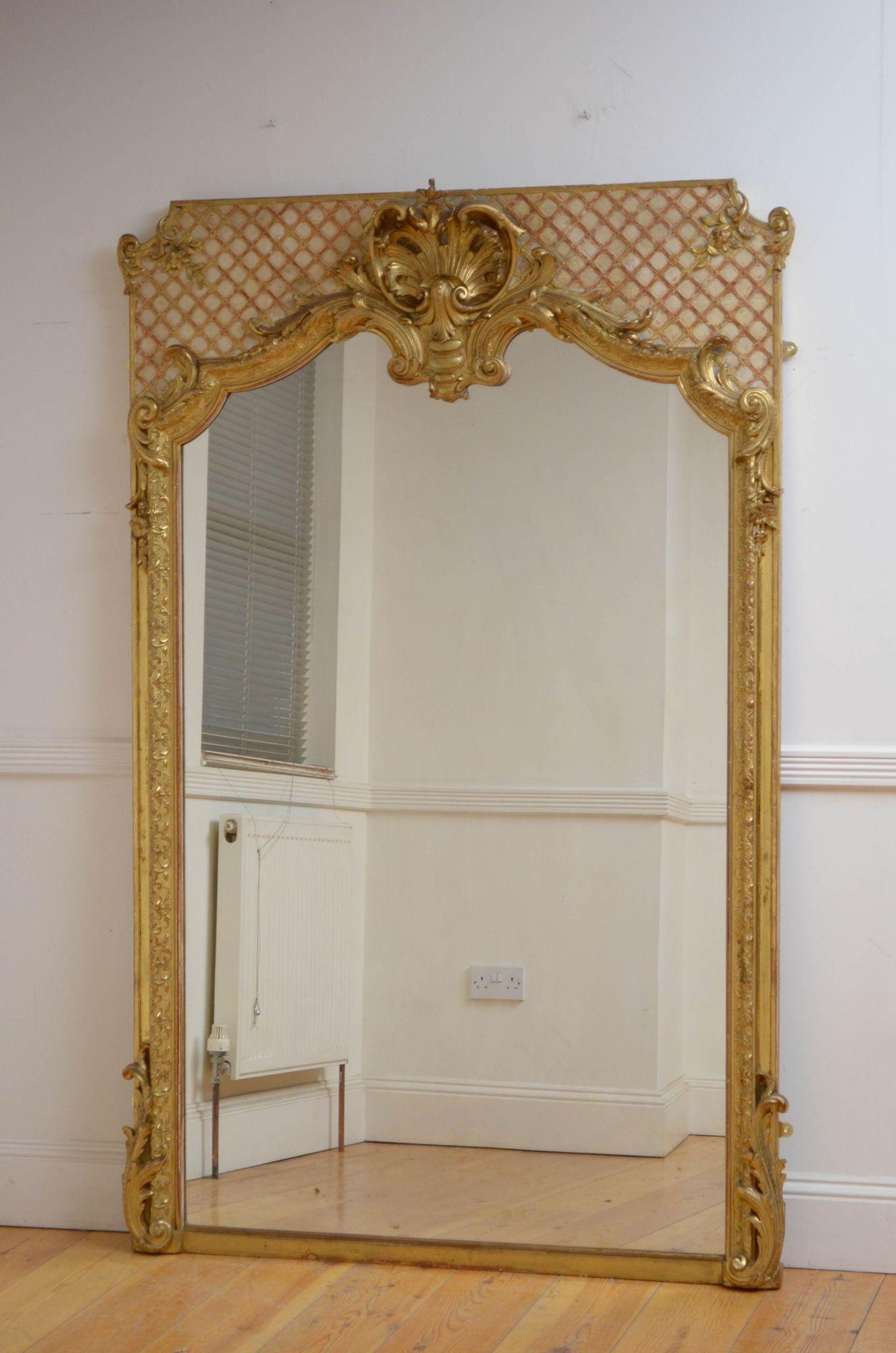 Sn5325 Superb XIXth century French giltwood mirror, having original glass with minor imperfections in moulded and gilded frame which is decorated with elaborate scrolls, flowers and shell to the centre all on lattice decorated back. This antique