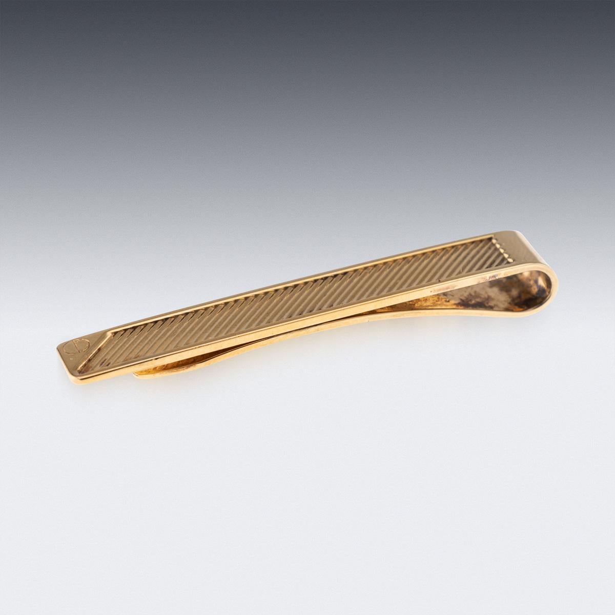 A stunning 20th Century gold plated solid silver money clip by Dunhill, England. Made in an elegant, simple design with an engine turned pattern. Presented with its original box, hardly ever seen as they are usually discarded, making it an ideal