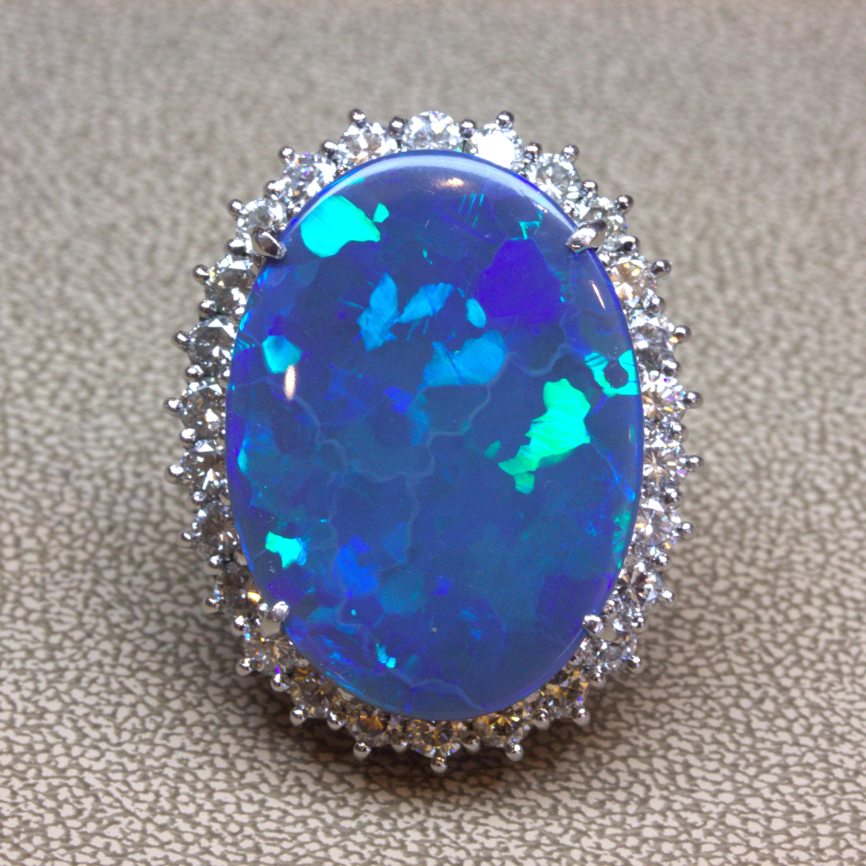 Simply breath-taking! Weighing in at almost 25 carats, this natural Australian black opal is an unbelievable treasure. Not only does it possess a very high carat weight, but it also has very strong play-of-color. Large and bright flashes of color,