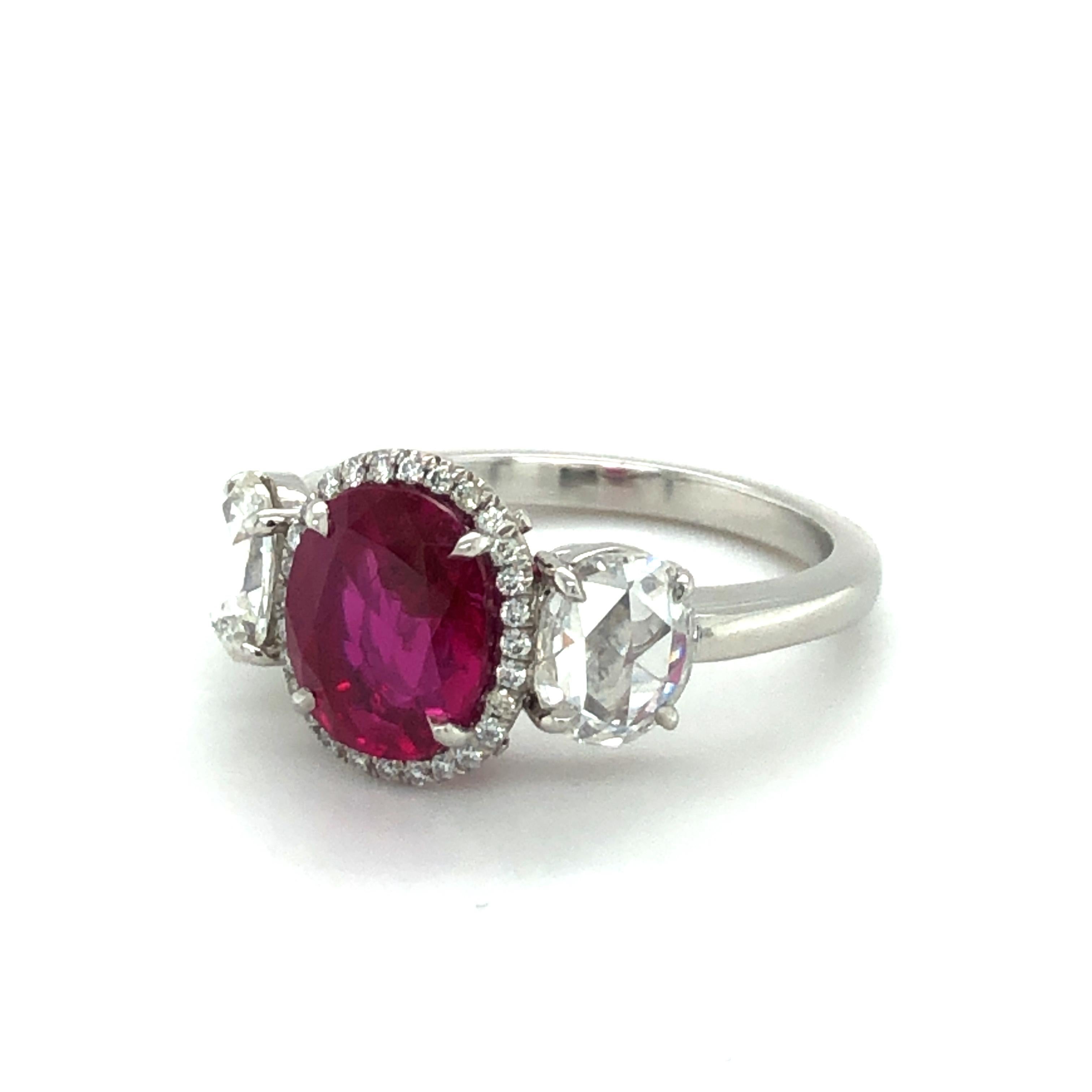 This stunning three-stone ring features a superb 2.73 ct Burma Ruby and two rose cut diamonds of H/I color and si1 clarity, total weight 1.10 carats.
The delicate entourage around the ruby consists of 27 brilliant cut diamonds of G/H color and vs