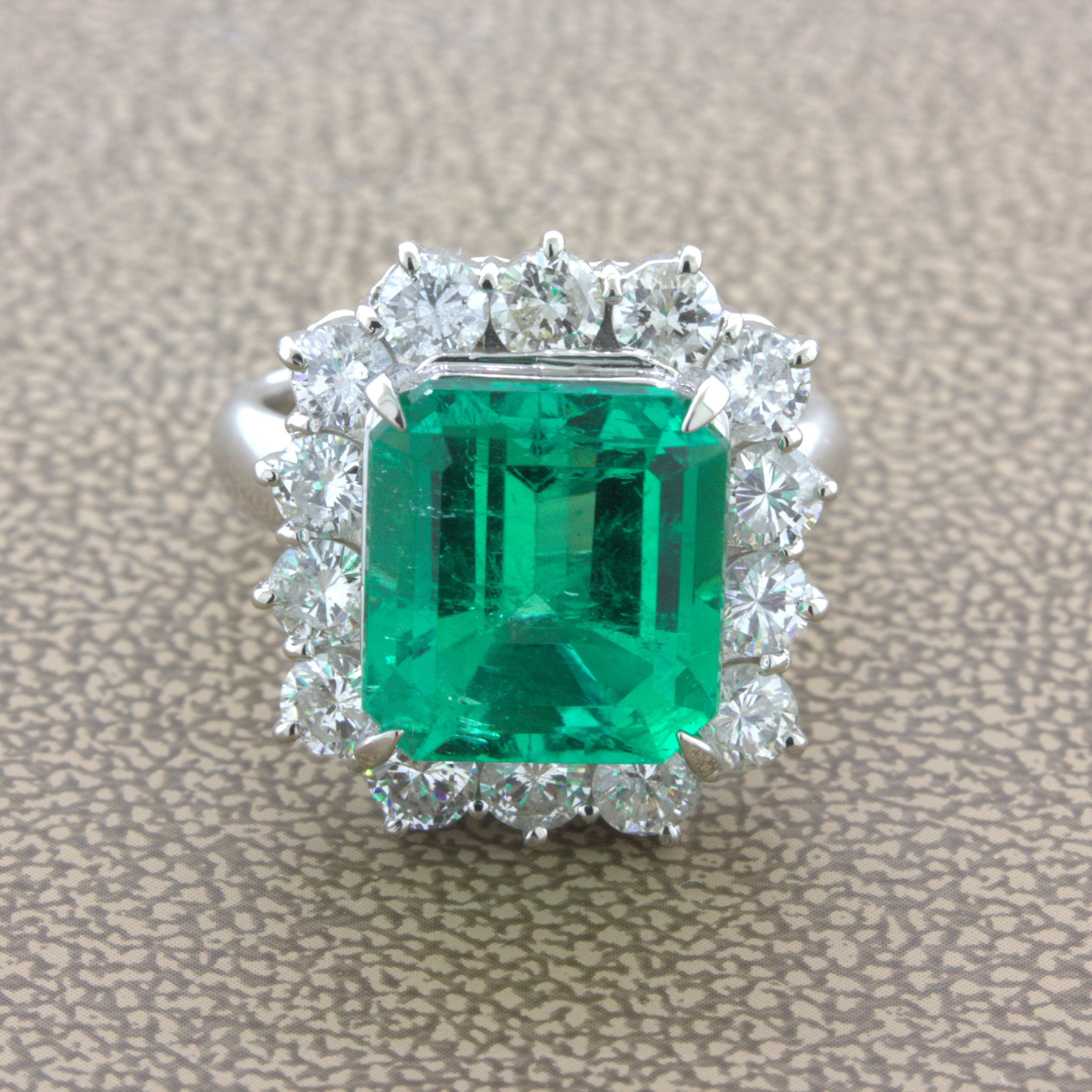 A true top-quality gem Colombian emerald weighing a very impressive 6.12 carats takes center stage. It has a super rich intense green color typical of the best stones from the Muzo region of Colombia. Adding to that, the stone is very clean compared