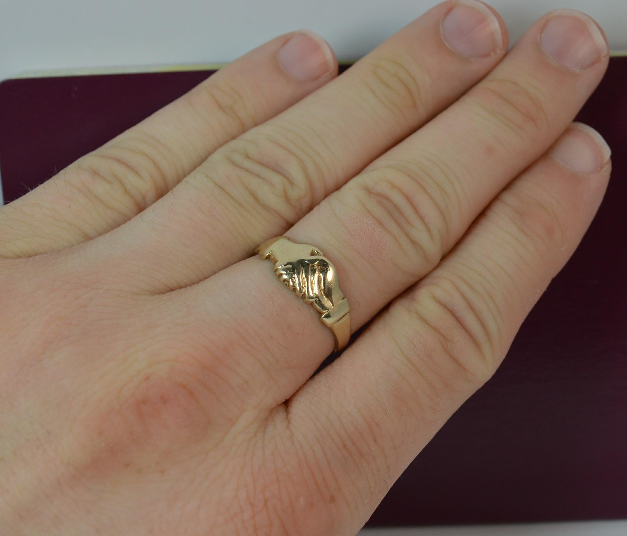 A superb claddagh or fede ring.
Size ; P 1/2 UK, 8 US
Solid 9 carat yellow gold example.
7.5mm wide band to the front.

Condition ; Very good. Clean band. Light wear only.
Please view photographs though note they are significantly bigger than the