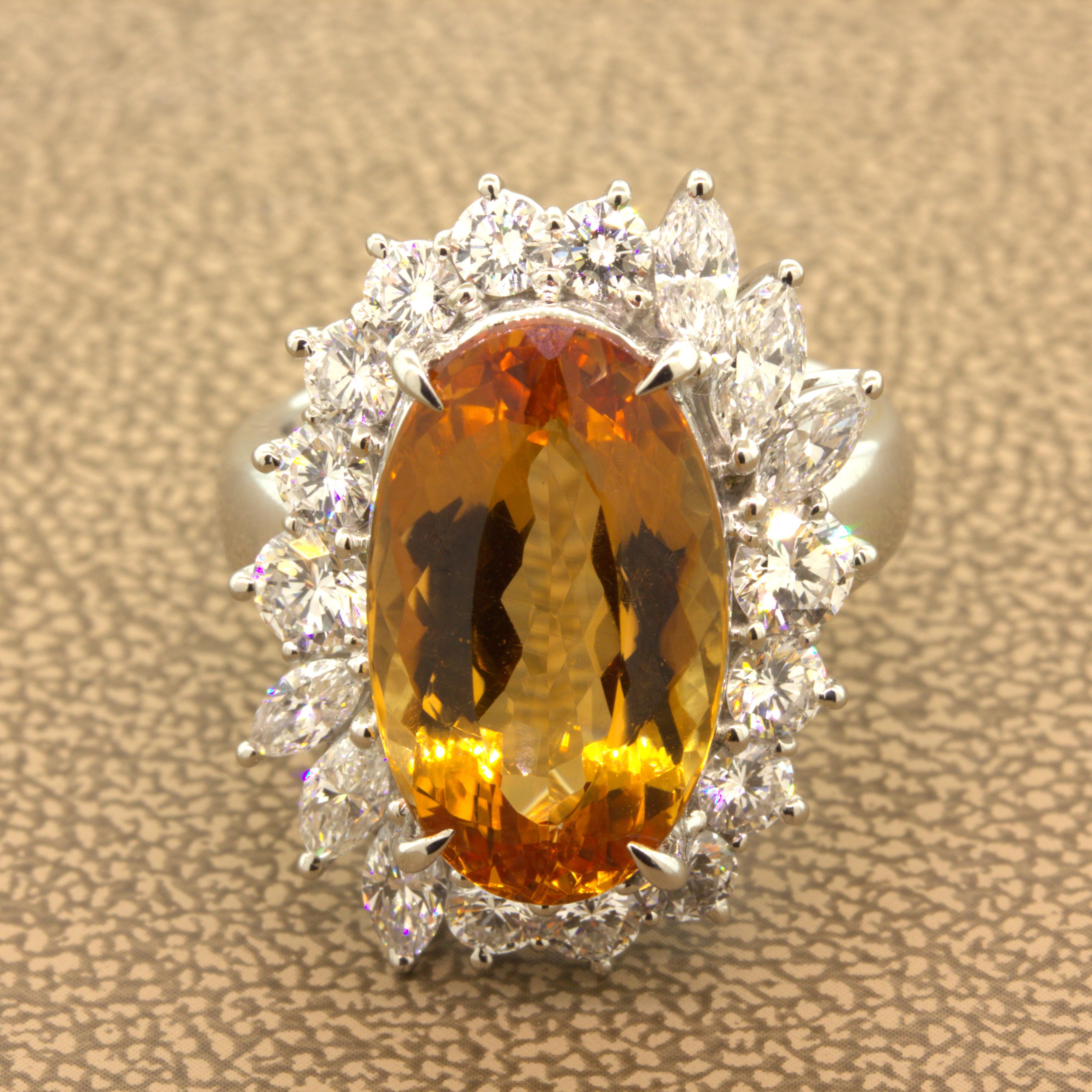 As good as it gets! This absolutely gorgeous platinum ring is one of our favorites in our entire collection! It features a long oval-shape imperial topaz, weighing 9.60 carats, with a rich intense golden orange/red color that scintillates in the