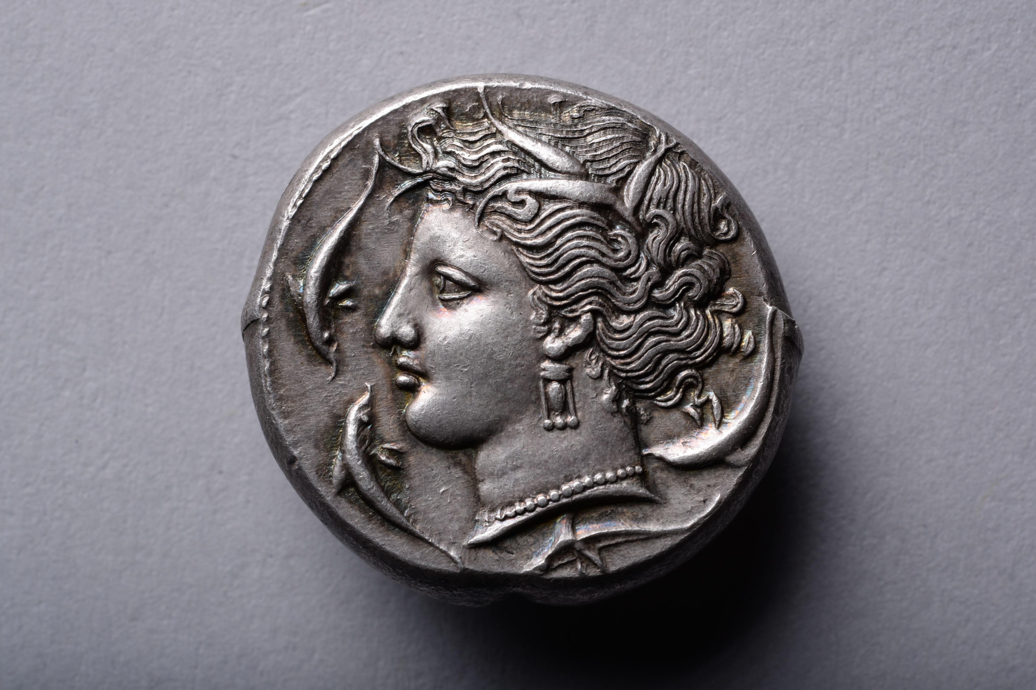 A superb silver tetradrachm issued by the Carthaginians at the Entella mint, during their occupation of Sicily. The obverse with a portrait of the nymph and patron of Syracuse, Arethusa, encircled by four playful dolphins. The reverse with the