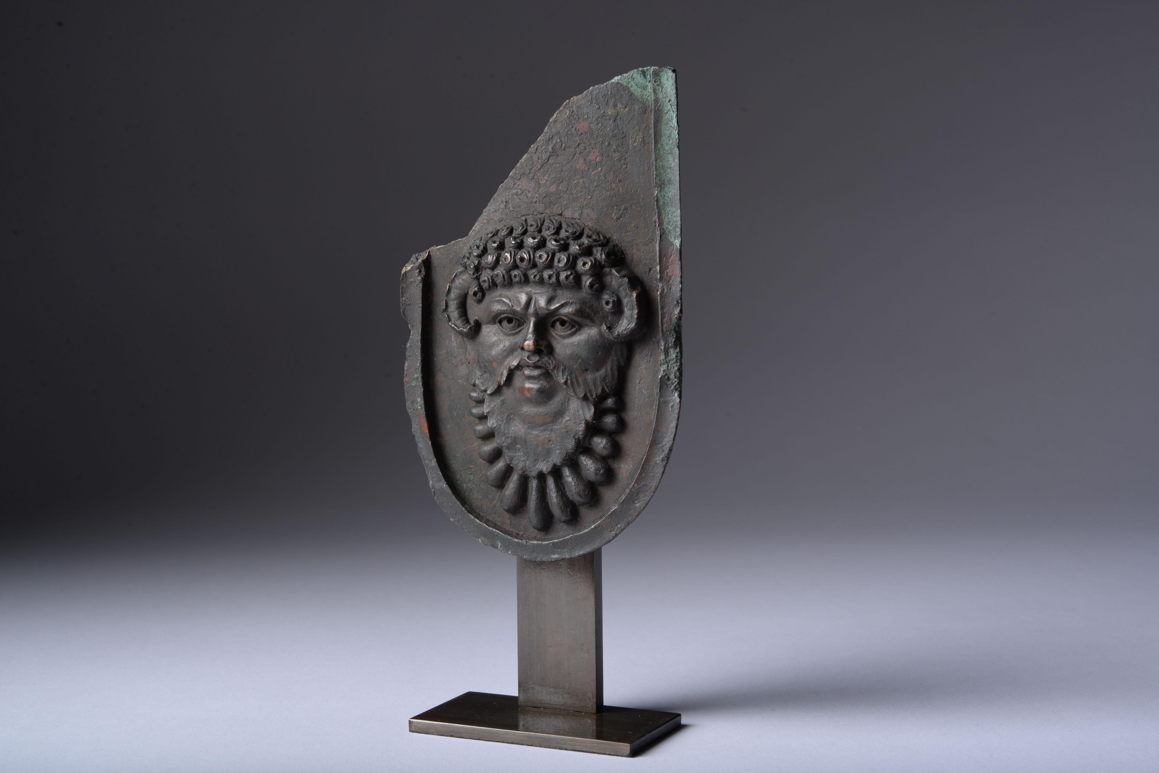 Fragment from an Over Life-Size Roman Imperial Statue, 1st - 2nd century AD.

An extraordinary bronze fragment from the cuirassed statue of a Roman Emperor, an important genre of official portraiture depicting the princeps in a highly decorated