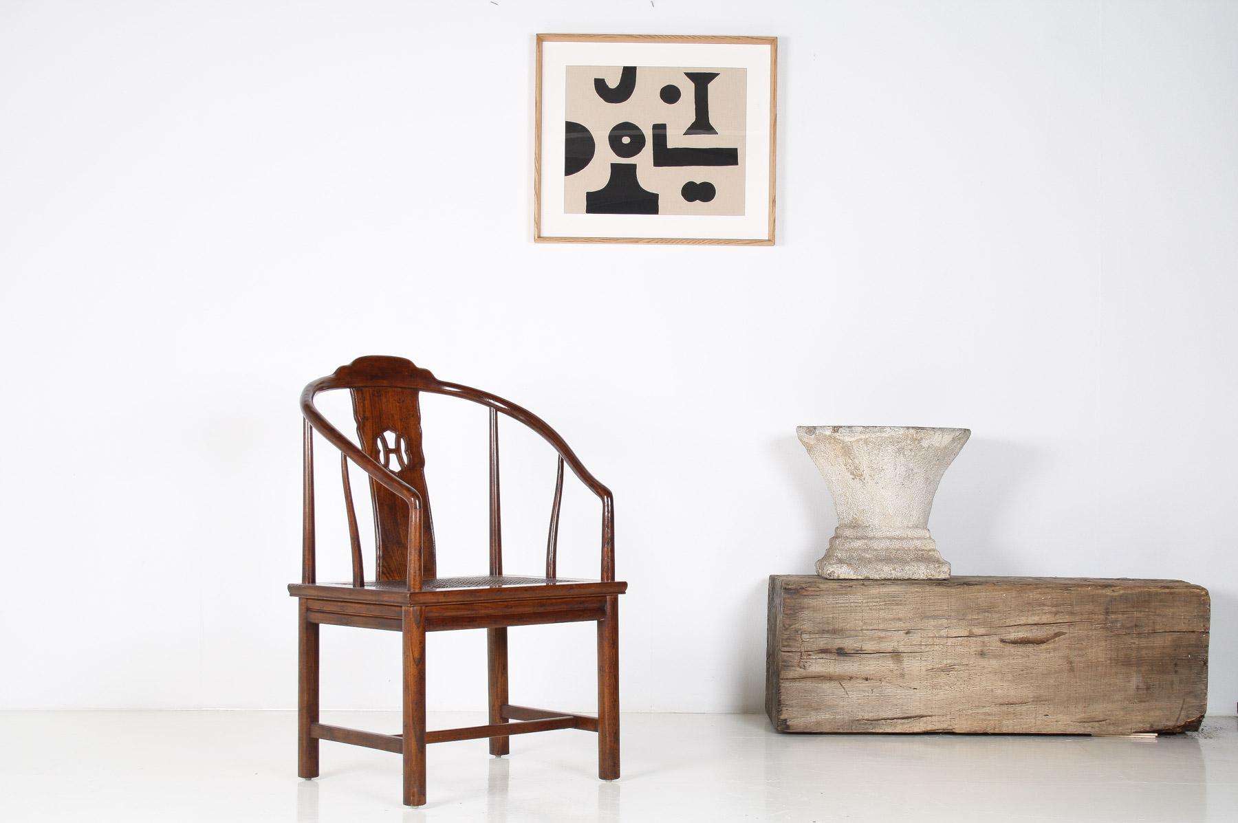 Chaise en fer à cheval chinoise du début du XXe siècle, de la fin de l'époque Qing ou du début de la République. Superbe forme avec dossier en fer à cheval et accoudoirs en balayage, dossier sculpté d'une seule latte verticale avec rondeau, assise