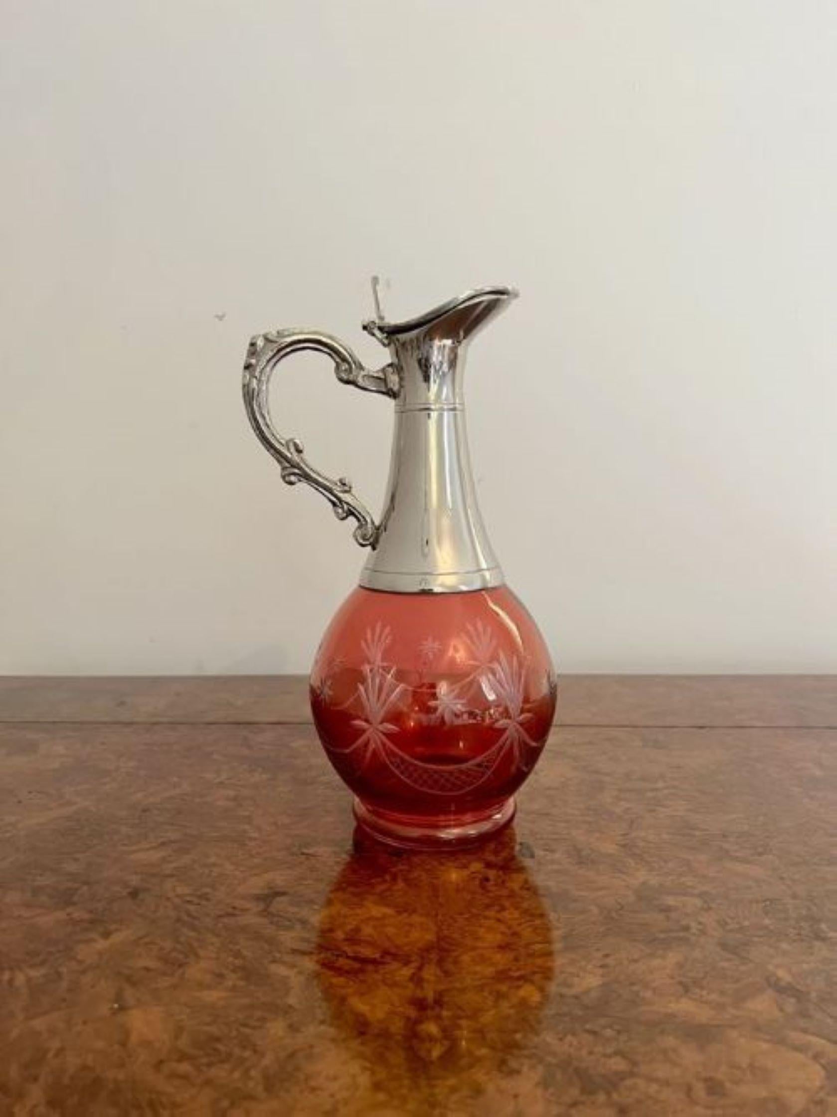 Superb antique Edwardian cranberry glass wine decanter having a wonderful cranberry glass decanter etched with stars with a silver plated neck and a quality ornate shaped handle 
