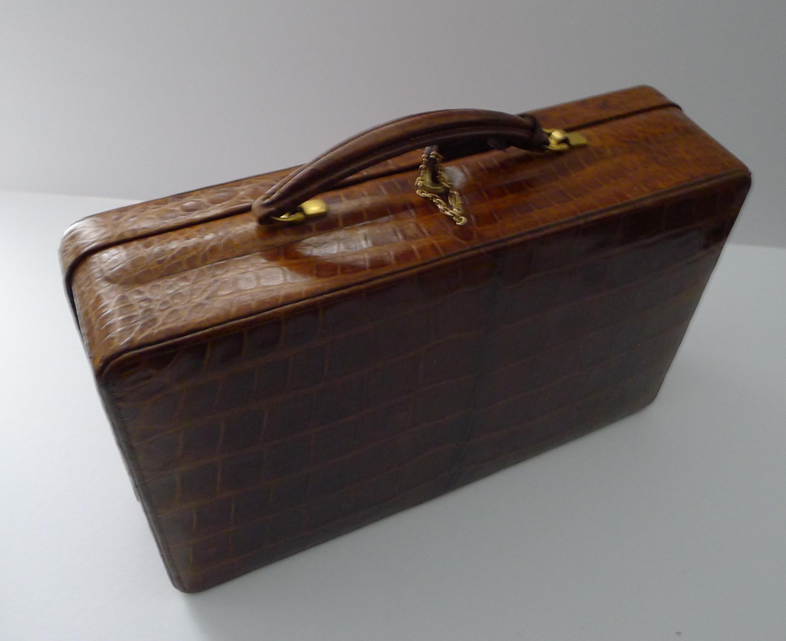 A stunning antique English Jewelry case made by the top notch, Mappin & Webb of London.

The case is covered in luxurious cognac coloured Crocodile, dating c.1910.  The case comes with a working 