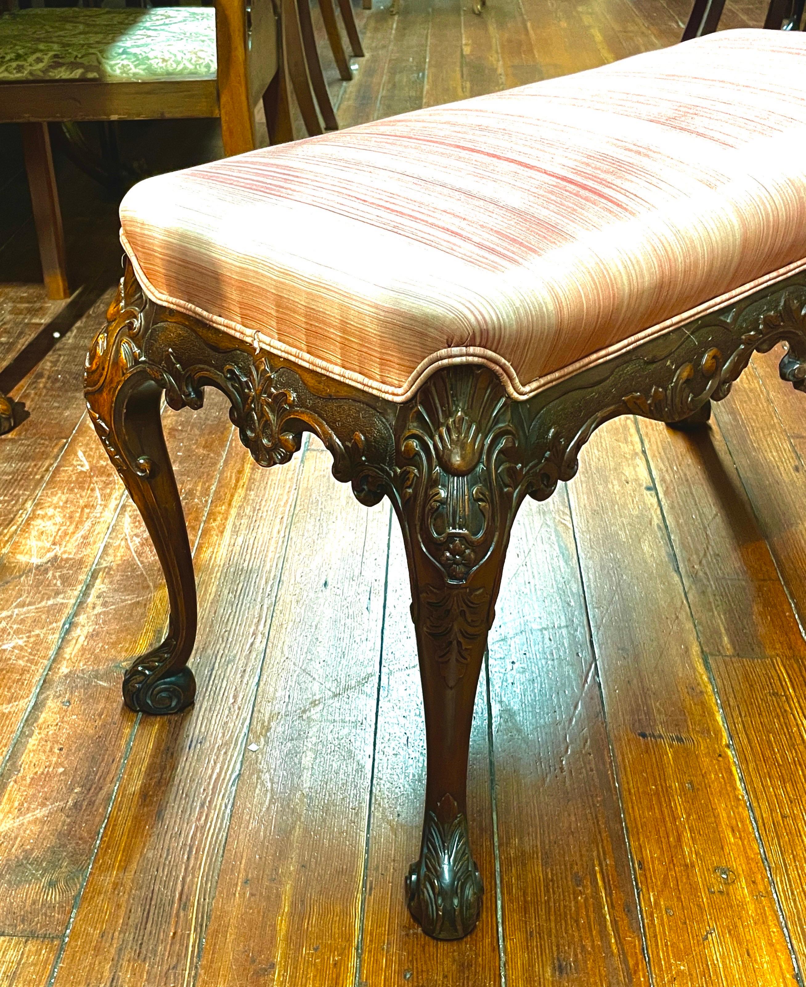 Superb Quality Antique English hand carved solid mahogany Georgian style Bedside or Fireside Bench. The hand carved frame is extraordinarily well done with superb details including the scrolled feet and cartouches each side. The fabric is a rose cut