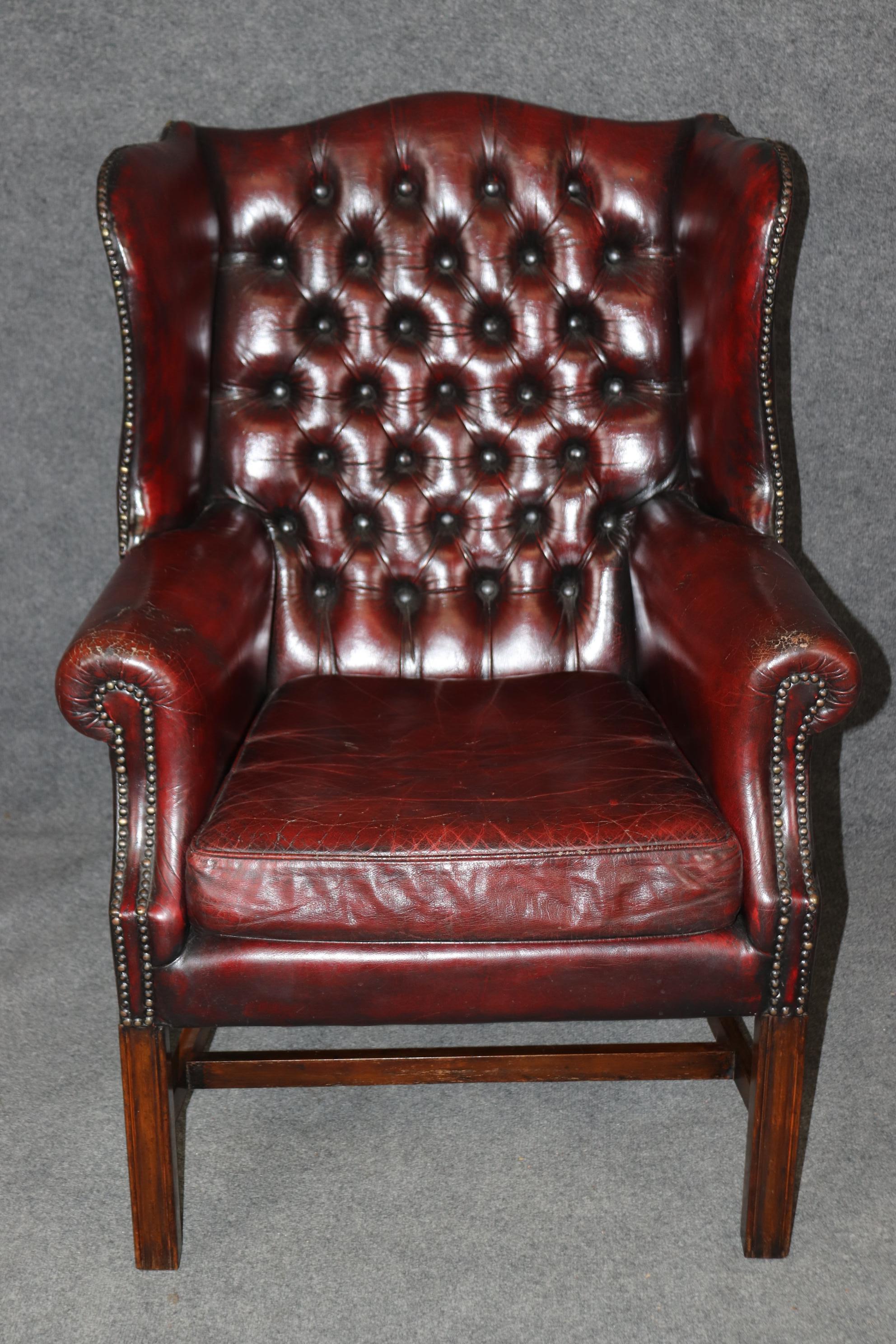 This is a chair with loads of character. Winston Churchill would have loved this chair! The chairs is pre-war English and has gorgeous brass nailheads around the trim with fantastic patina and a nice crackled aged patina to the leather. The frame is