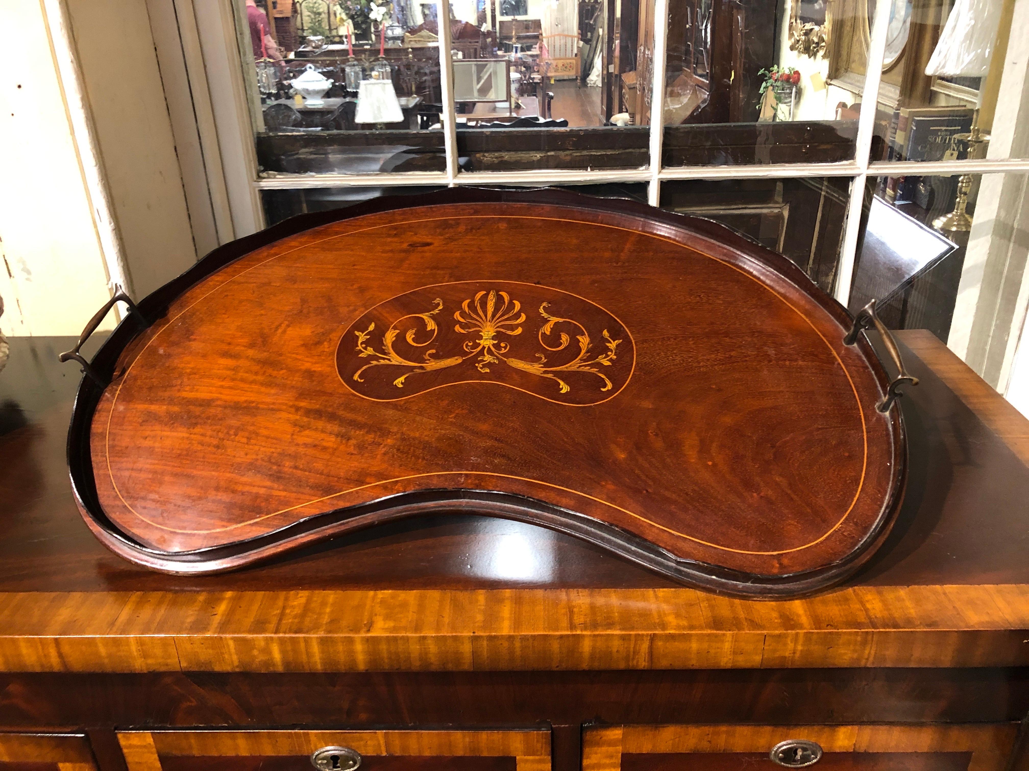 A wonderful and rare Antique English marquetry inlaid mahogany unusual kidney shape two handle tray; the handles are brass with a mahogany laminated gallery (some old repairs). (There are some old repairs to the gallery in a couple of different