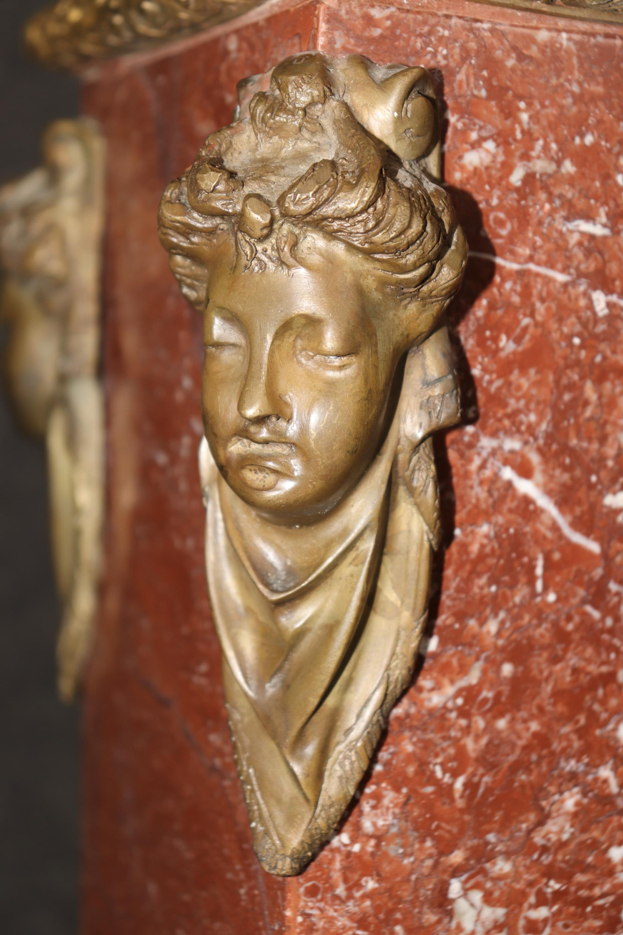 This is a fantastic rouge marble French-made Louis XV pedestal and features gorgeous cast bronze figural maidens at each corner and incredible cast bronze neoclassical columnal elements and such a beautiful color of rouge marble for the base. The