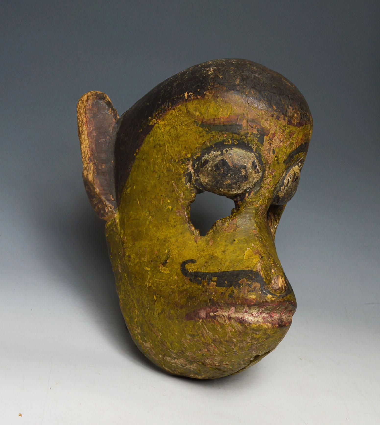 Nepalese temple festival mask of Hanuman the Monkey God
A superb very old temple/festival mask of Hanuman the monkey god
The smiling monkey god with protruding snout large ears curling mustache 
Ancient layered patina with remains of pigments from