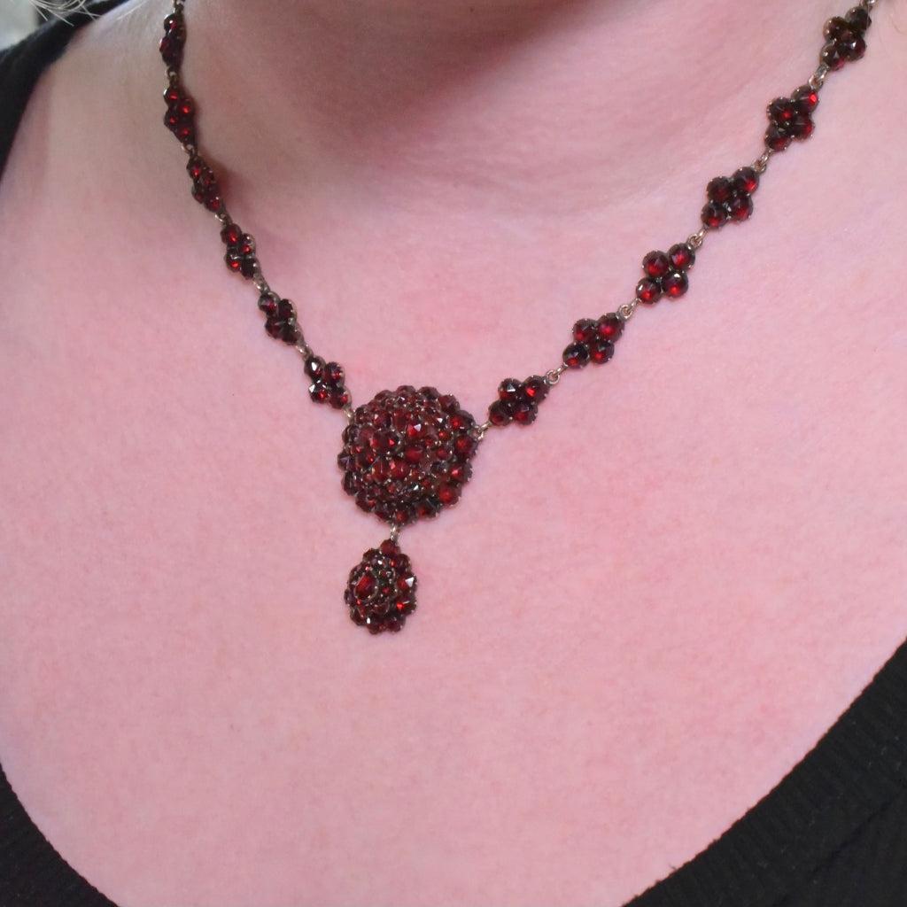Dating to the late Victorian era we have this superb Bohemian Garnet pendant necklace and its original flower cluster necklace with floral garnet set clasp.

Crafted from traditional ‘Tombac’ or garnet gold as its was also called and set with an