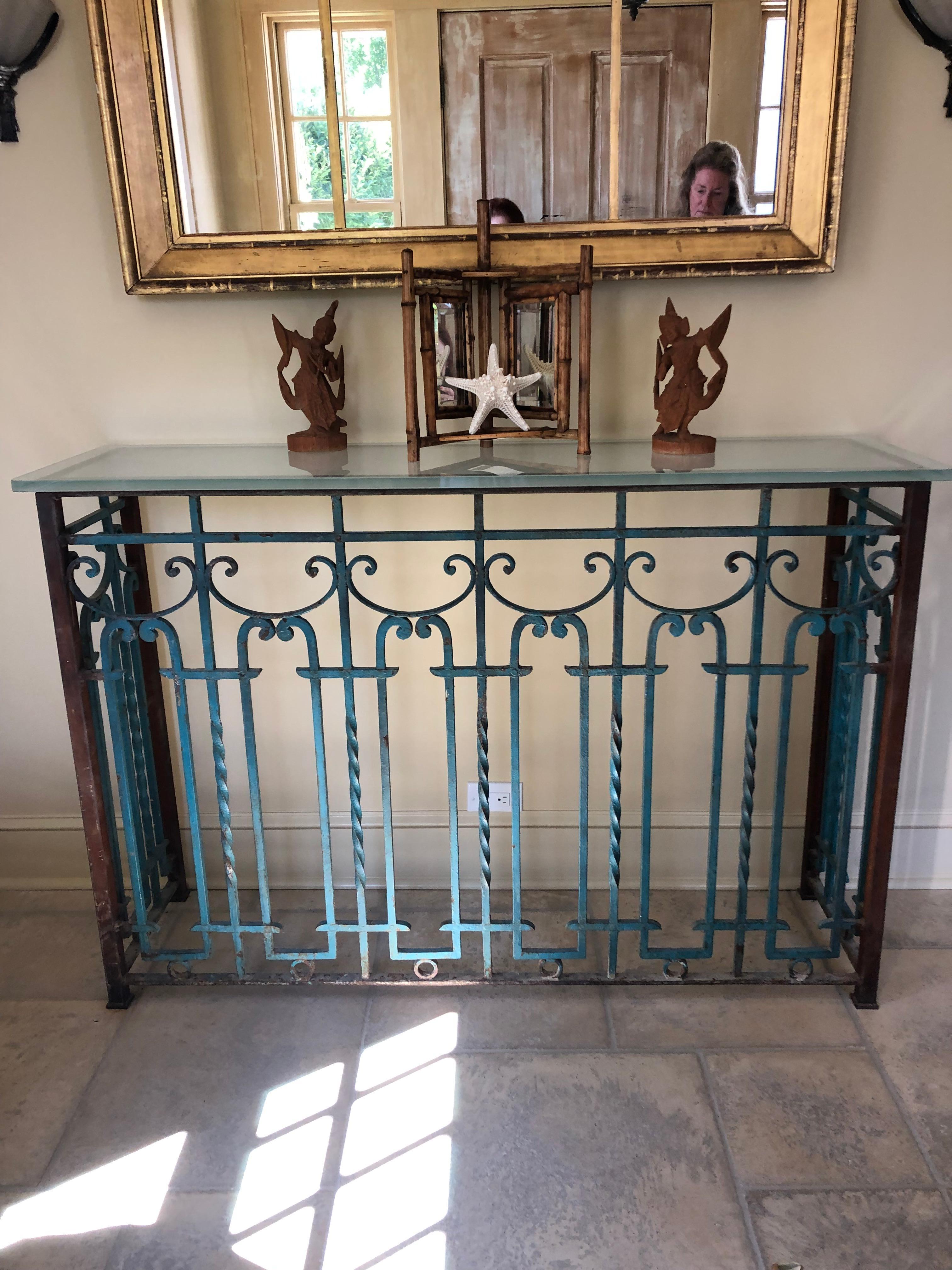 One of a kind show stopper console made from vintage architectural wrought iron grill or fencing having fabulous turquoise and red original chippy paint and topped with a .75