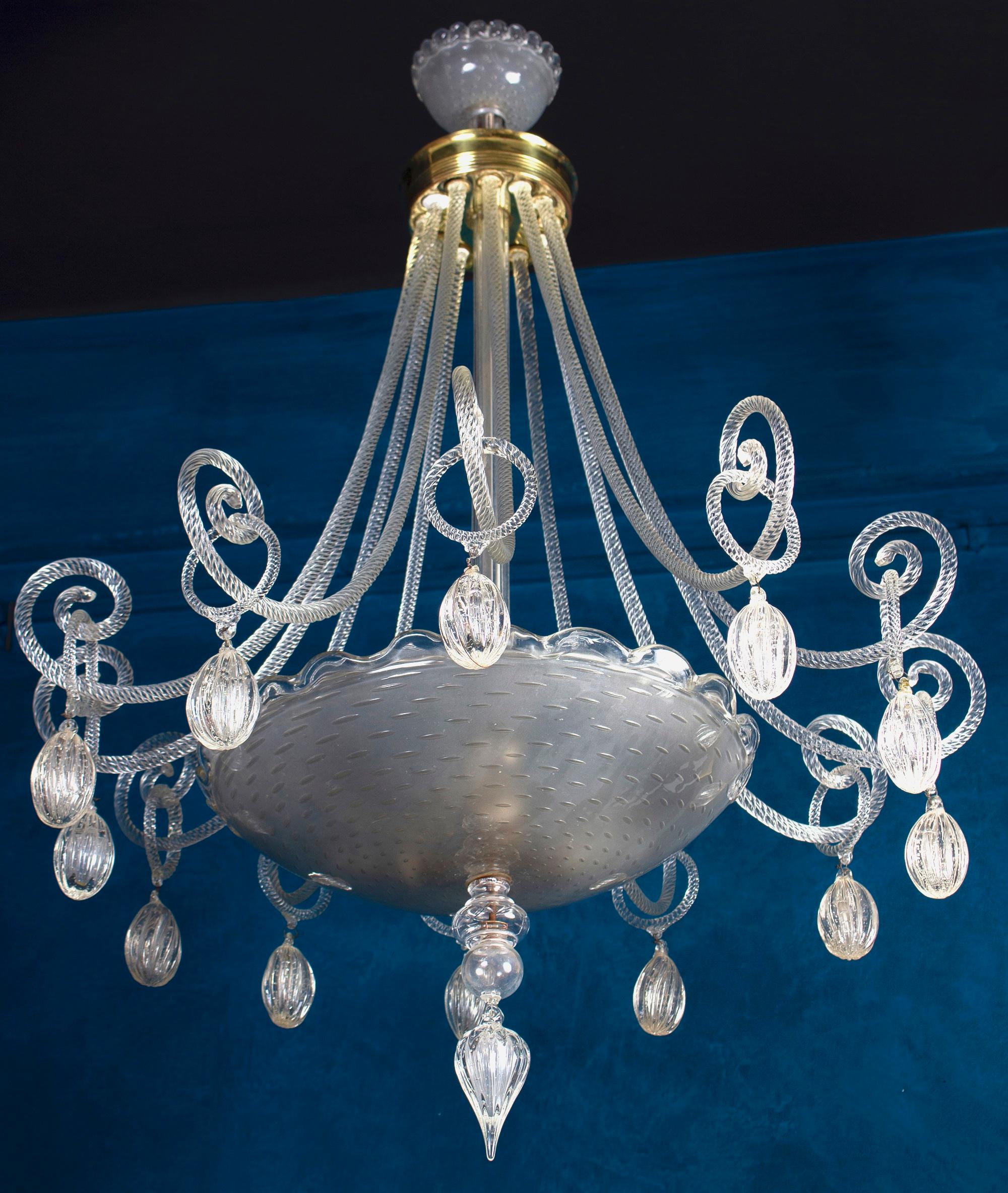 Elegant and rare Murano glass chandelier, made of precious hand blown clear glasses.
Cleaned and re-wired, in full working order and ready to use. In excellent vintage condition. This light fixture can be disassembled and the glasses individually