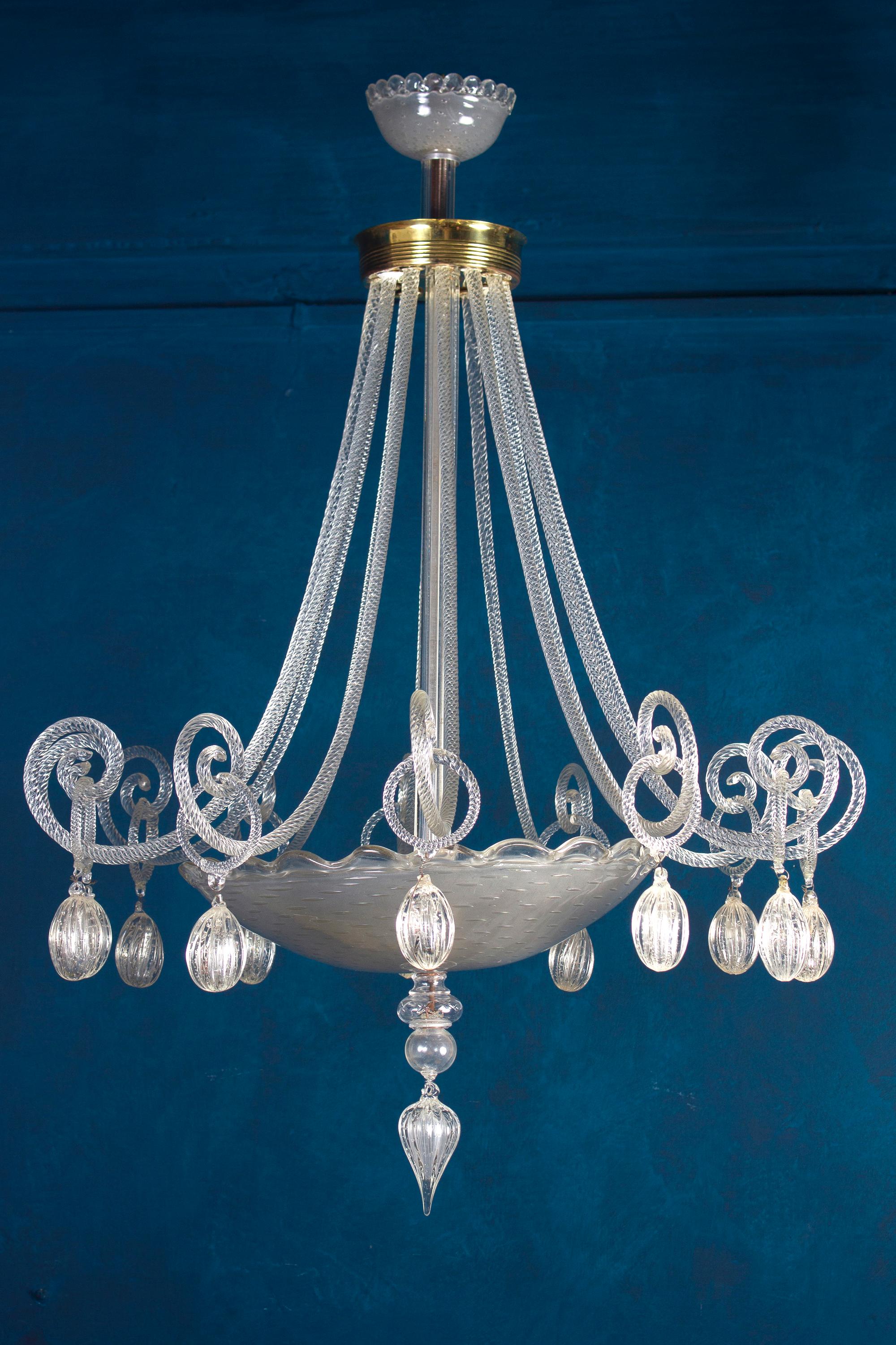 Elegant and rare Murano glass chandelier, made of precious hand blown clear glasses.
Cleaned and re-wired, in full working order and ready to use. In excellent vintage condition. This light fixture can be disassembled and the glasses individually