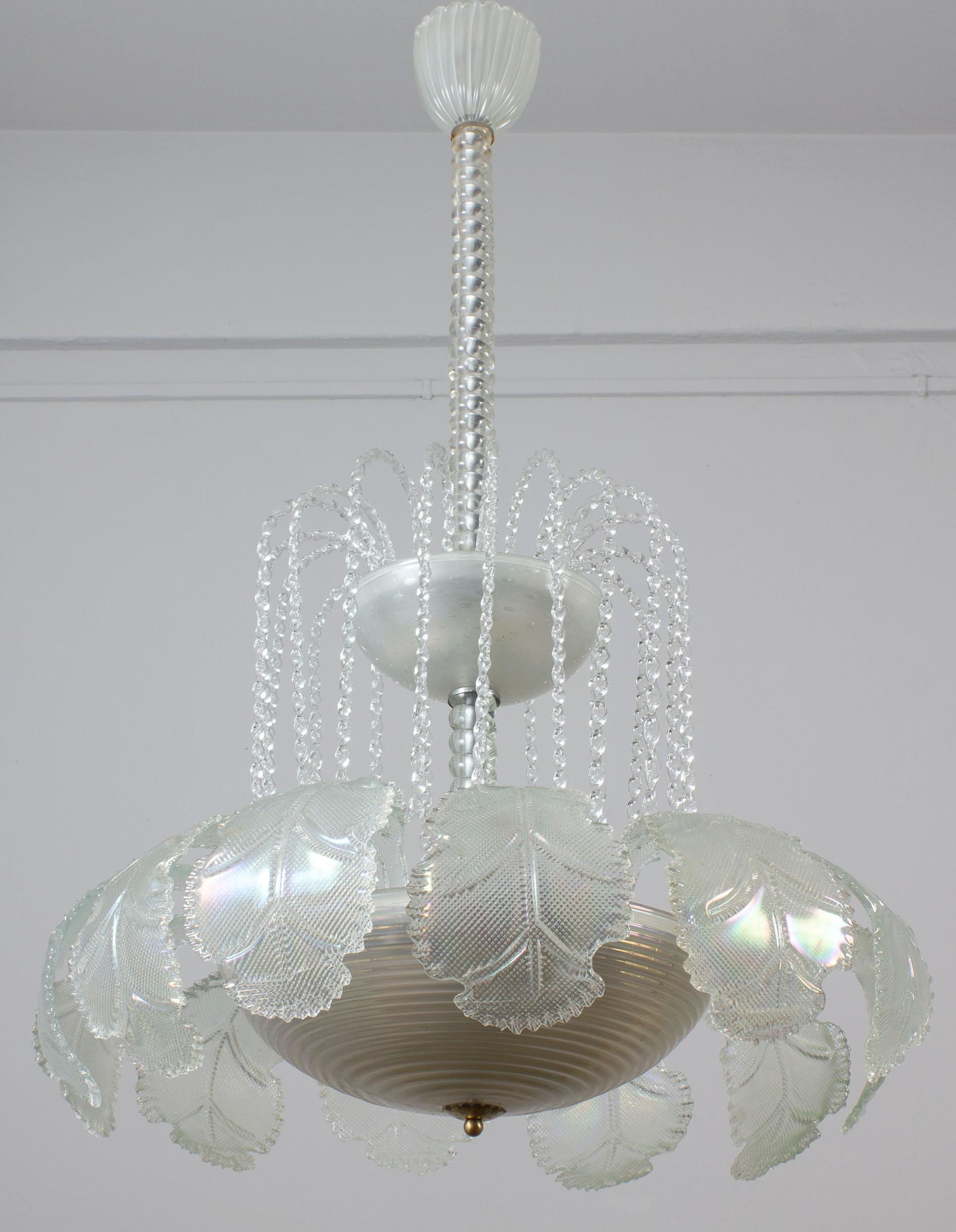 Amazing hand blown Ninfea Murano glass chandelier on two levels by Ercole Barovier. Cascade of  precious iridescent  hand blown leaves.
 Timeless elegance for your interior. 
Excellent vintage condition.
 We can wire the frame for US
