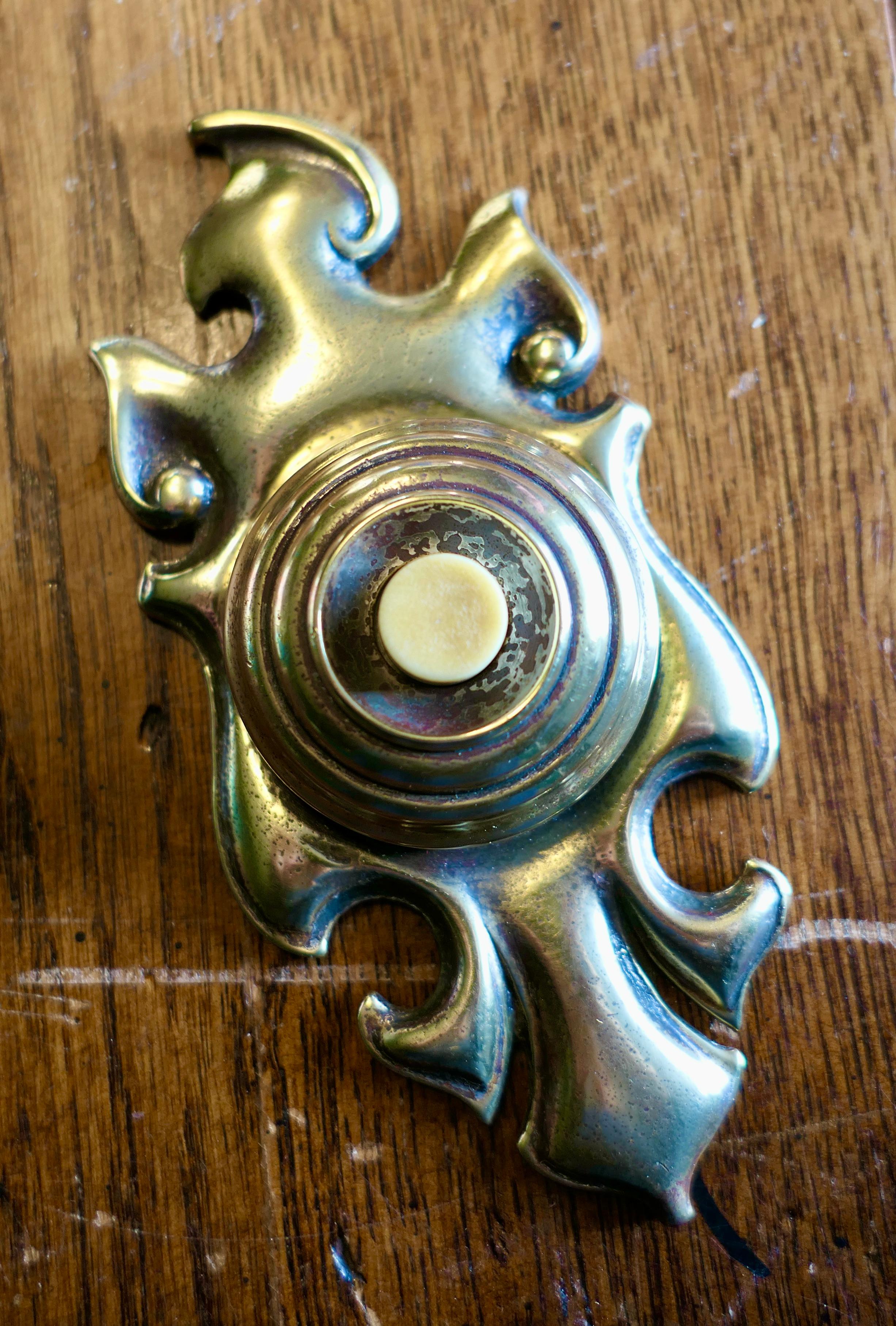 Superb Art Nouveau brass bell push

This is a superb looking piece, it has a 19th century registration marks on the back.
The condition both inside and out is very good and the bell push could be connected either to a battery or with the use of