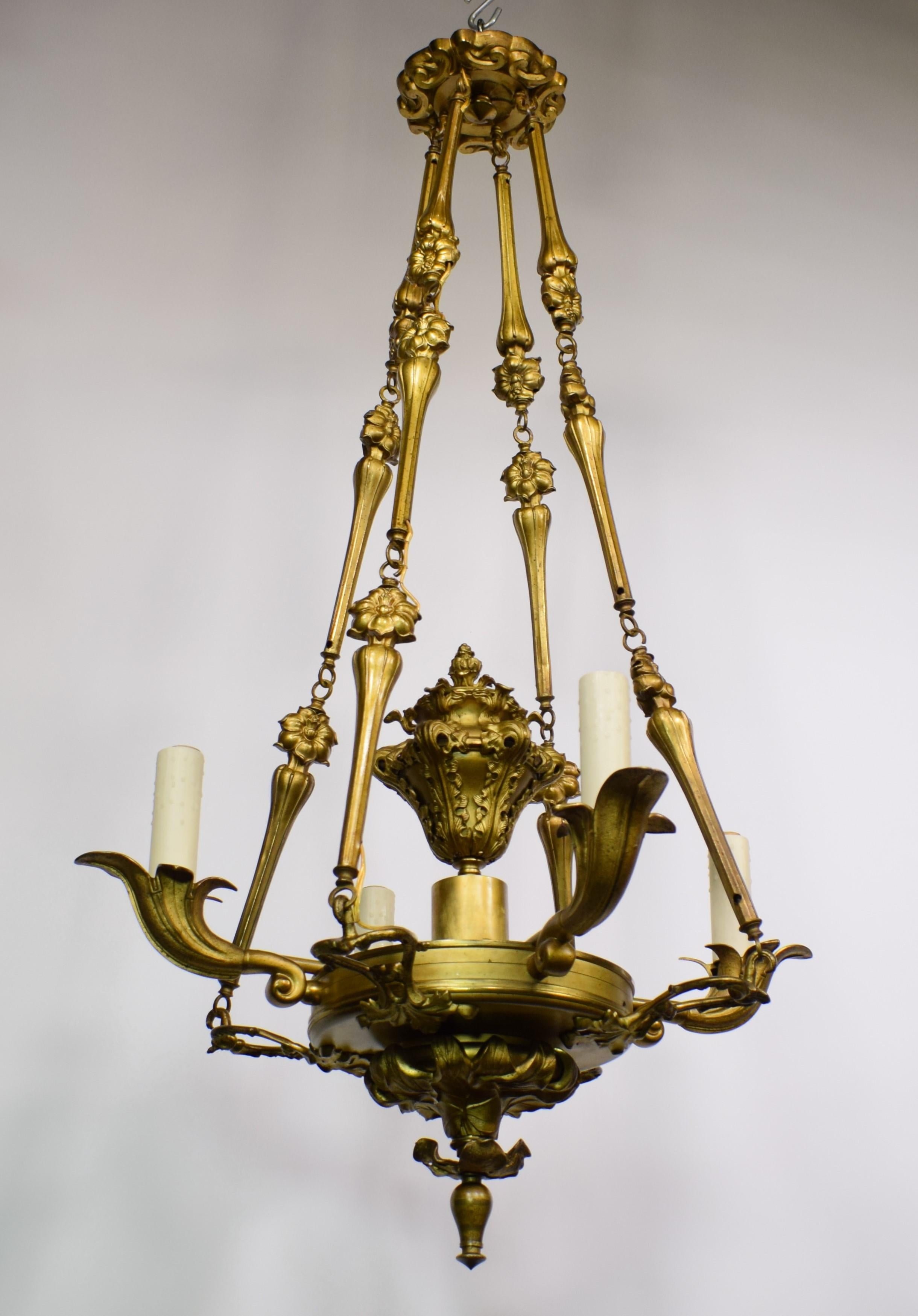 Superb Art Nouveau Gilt Bronze Chandelier. The ornamentation (incorporating leaves and other floral elements) makes this a wonderful example of early Art Nouveau. France, circa 190. 5 lights.
Dimensions: H: 53.5